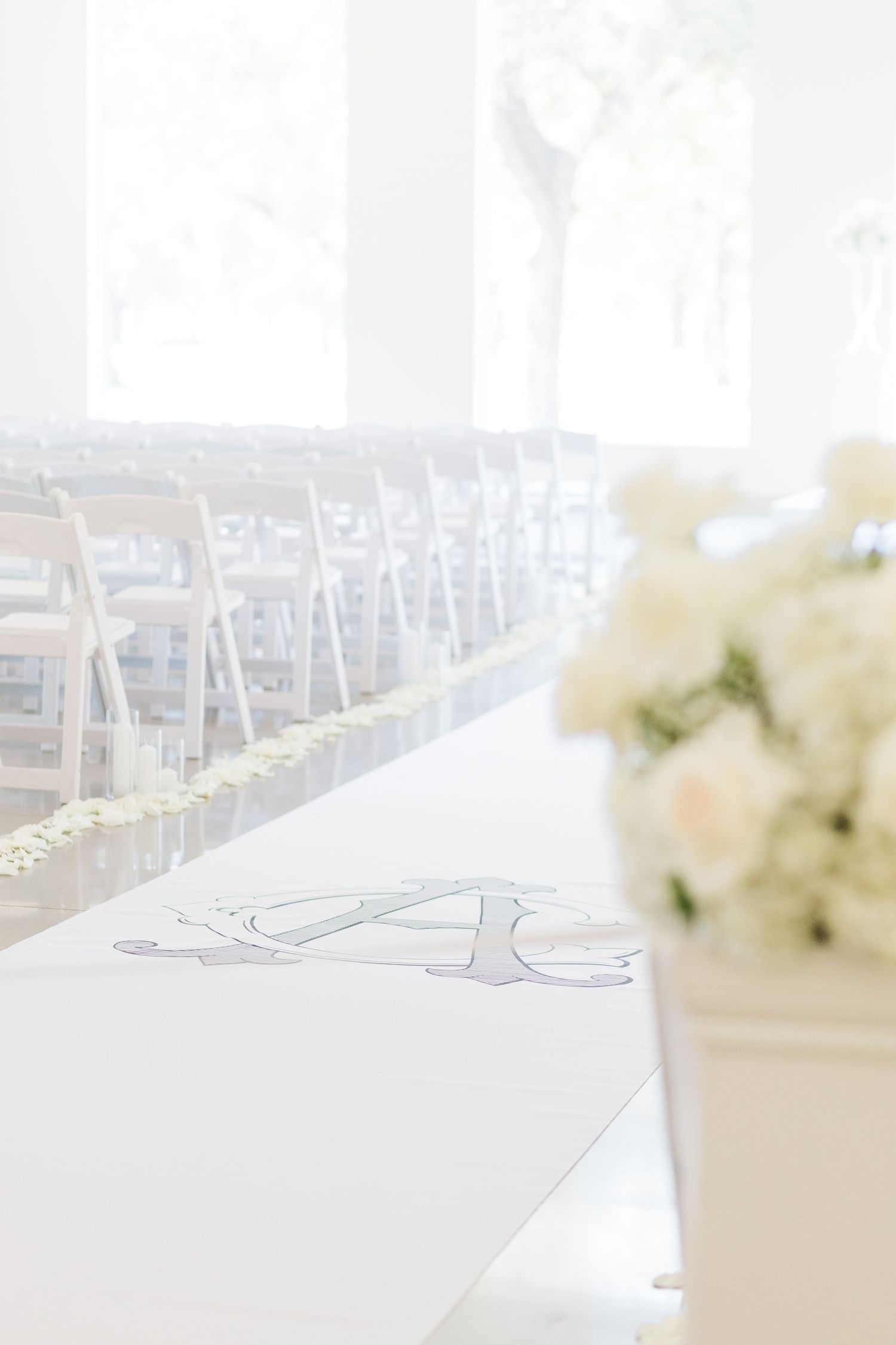 Light and airy ceremony design with custom floor runner.