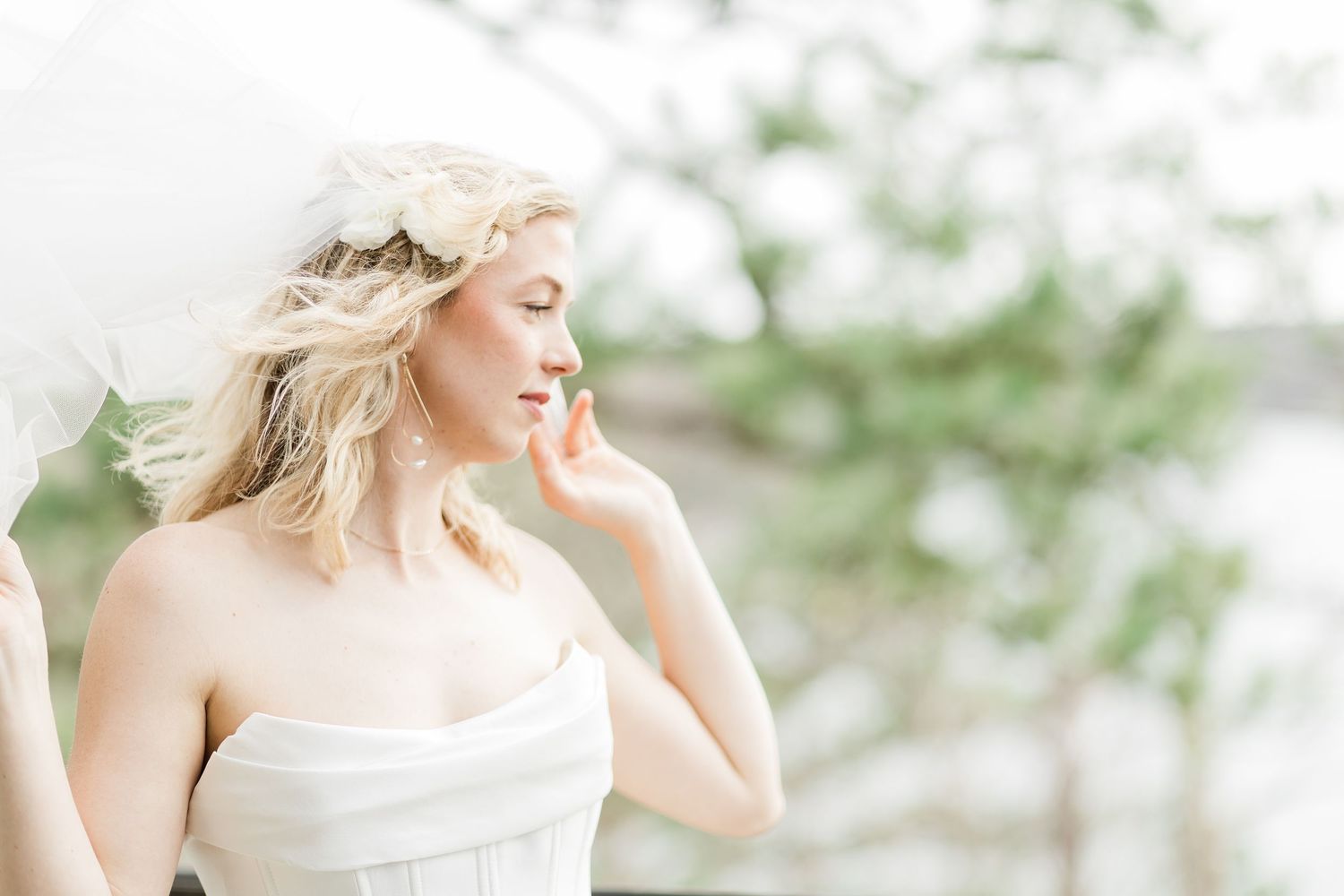 Bride posing in the wind with veil.