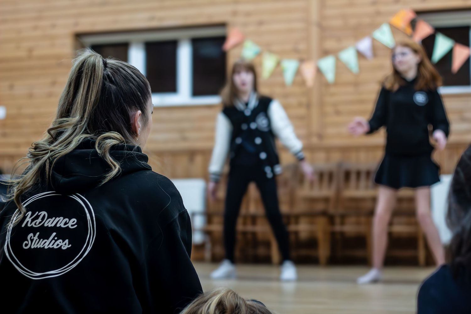 Dance practice session with bunting decorations visible in the background.
