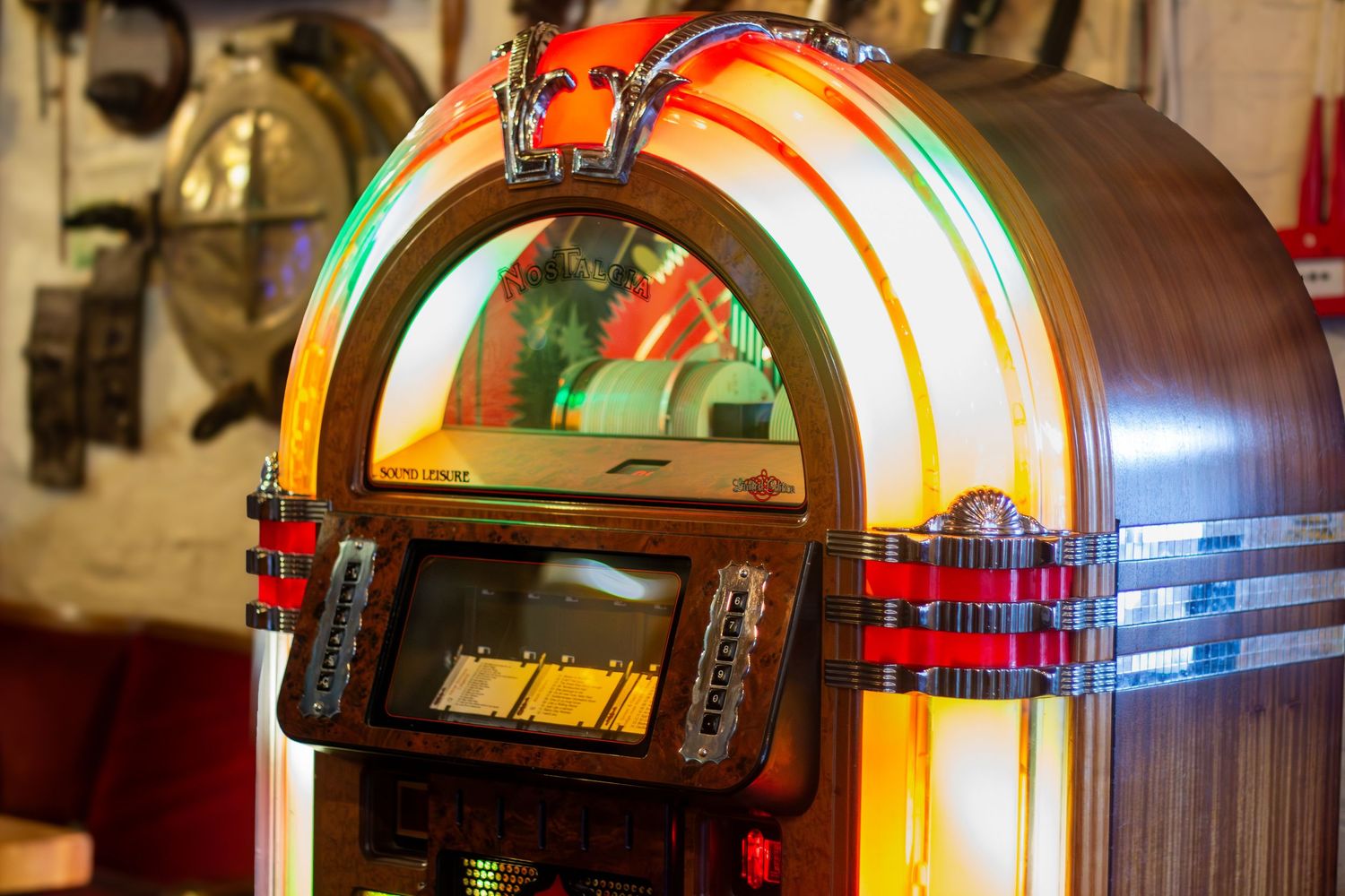 Vintage jukebox with colorful neon lights and classic design details in a dimly lit setting.
