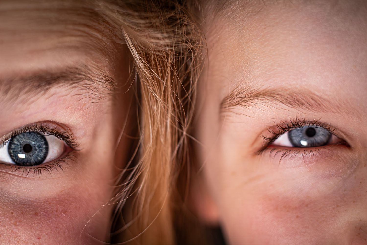 Close-up of two children with striking blue-gray eyes and blonde hair, showcasing detailed iris textures.
