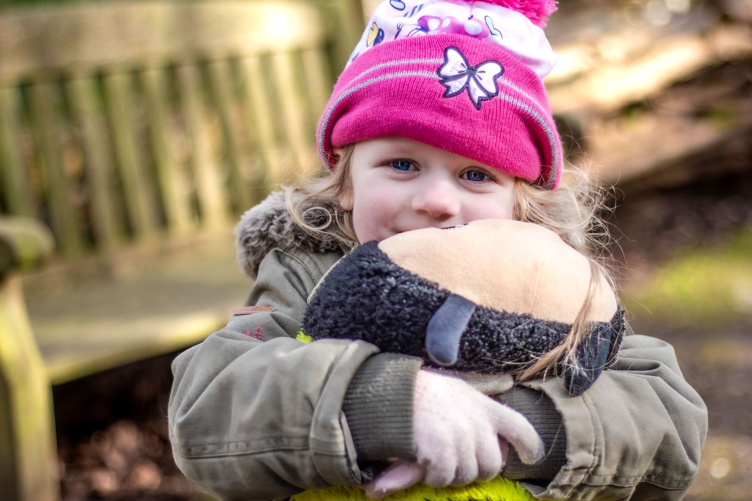 People in winter hats and coats enjoying outdoor activities.
