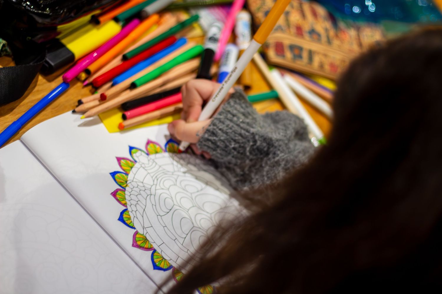 Colorful art supplies and pencils arranged on a creative workspace.
