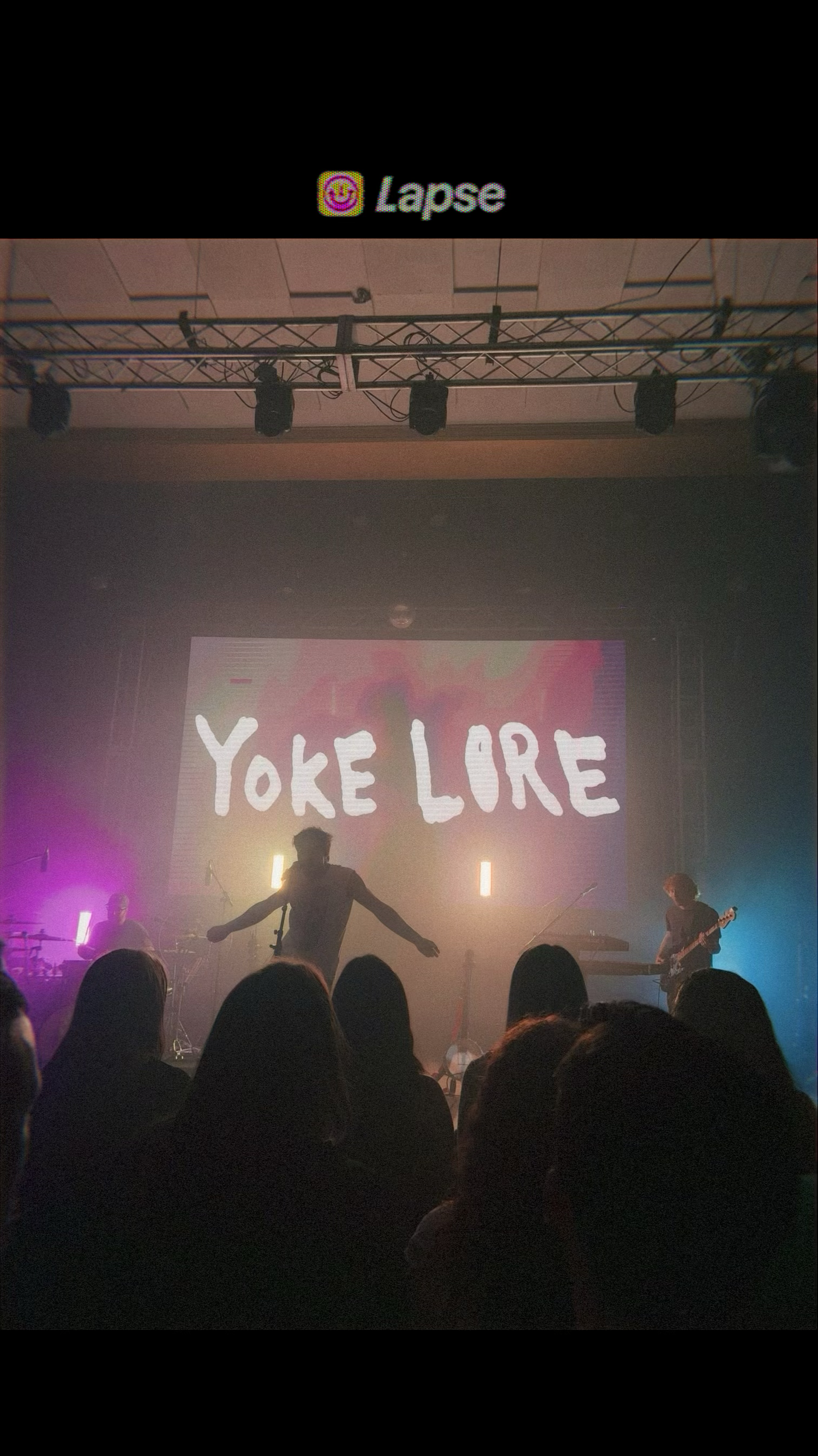 Yoke Lore performer on stage with arms outstretched at an indoor concert venue Indianapolis senior photographer Regan Nichalson Creative