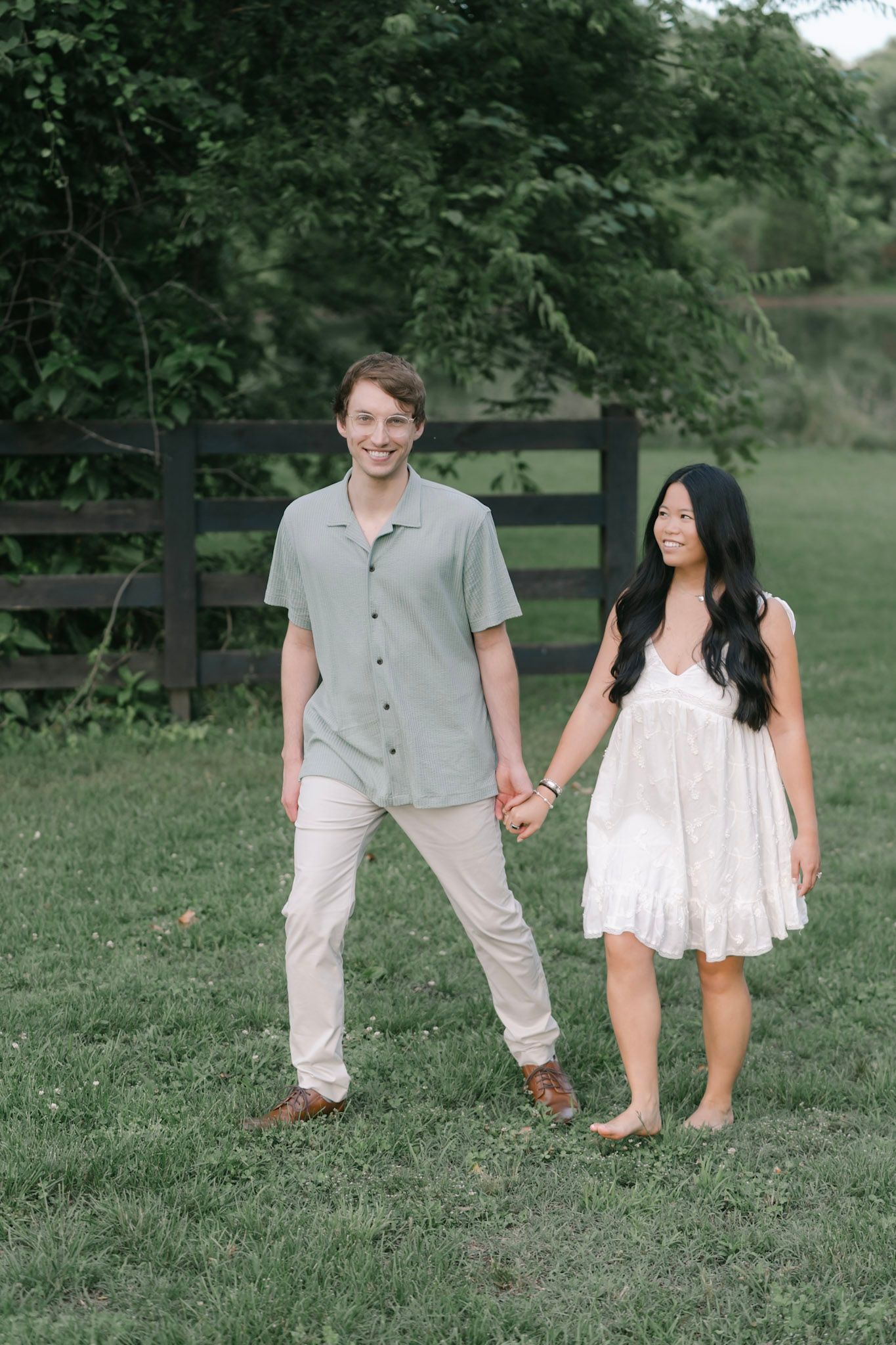 couple smiling and walking together during their Brentwood engagement session