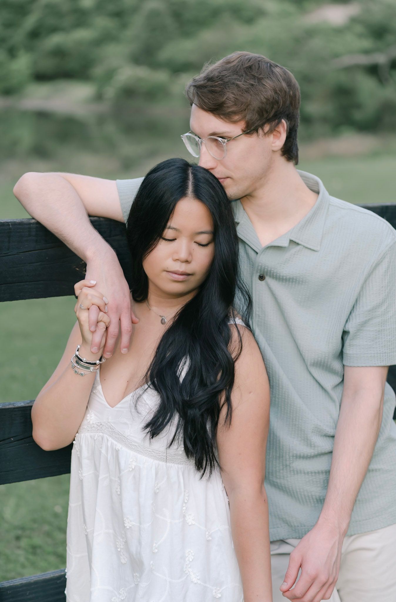 fiancé kissing his partners forehead during a romantic engagement photo session
