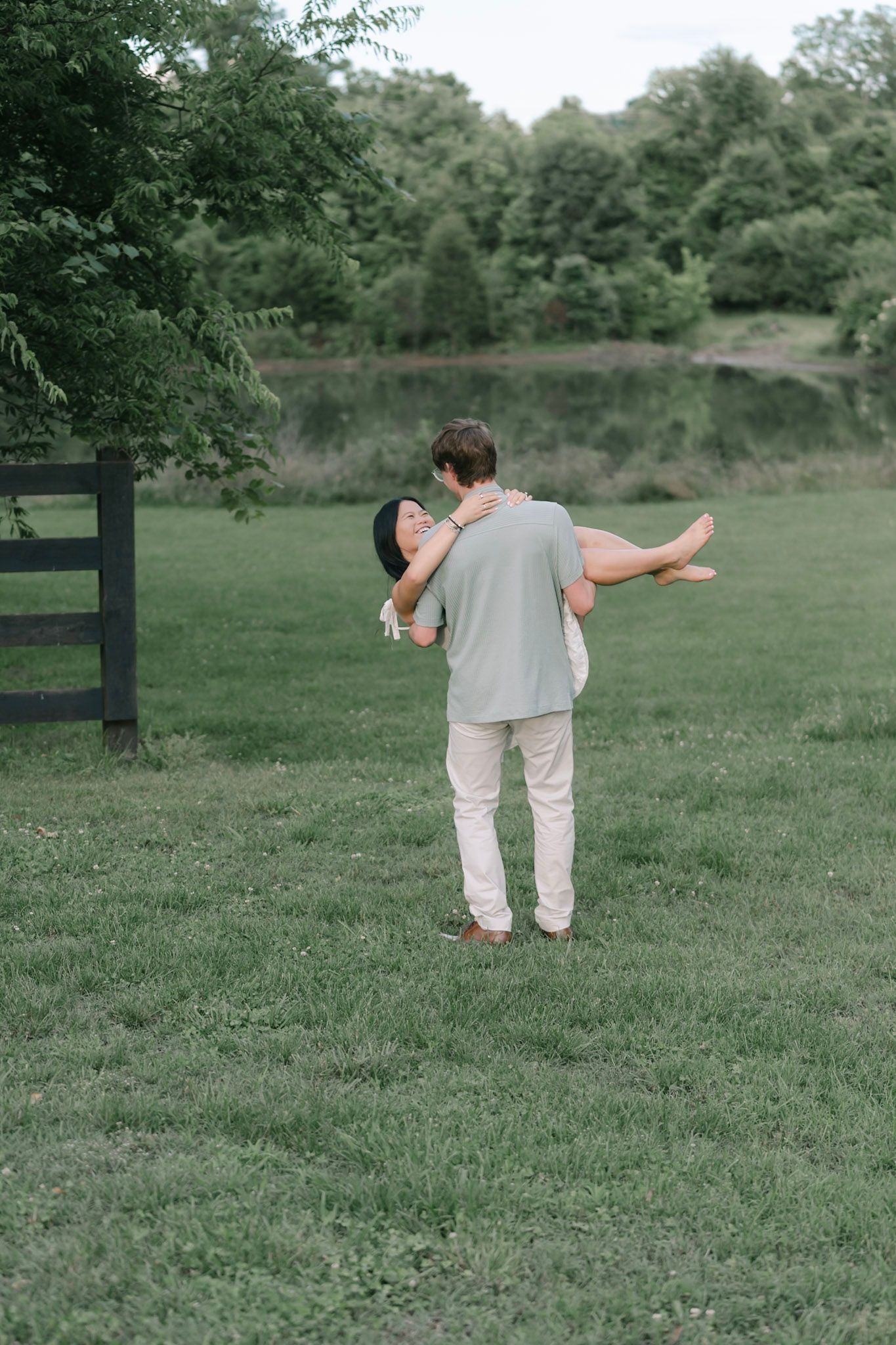 Couple cuddling together during a relaxed outdoor engagement session near Nashville