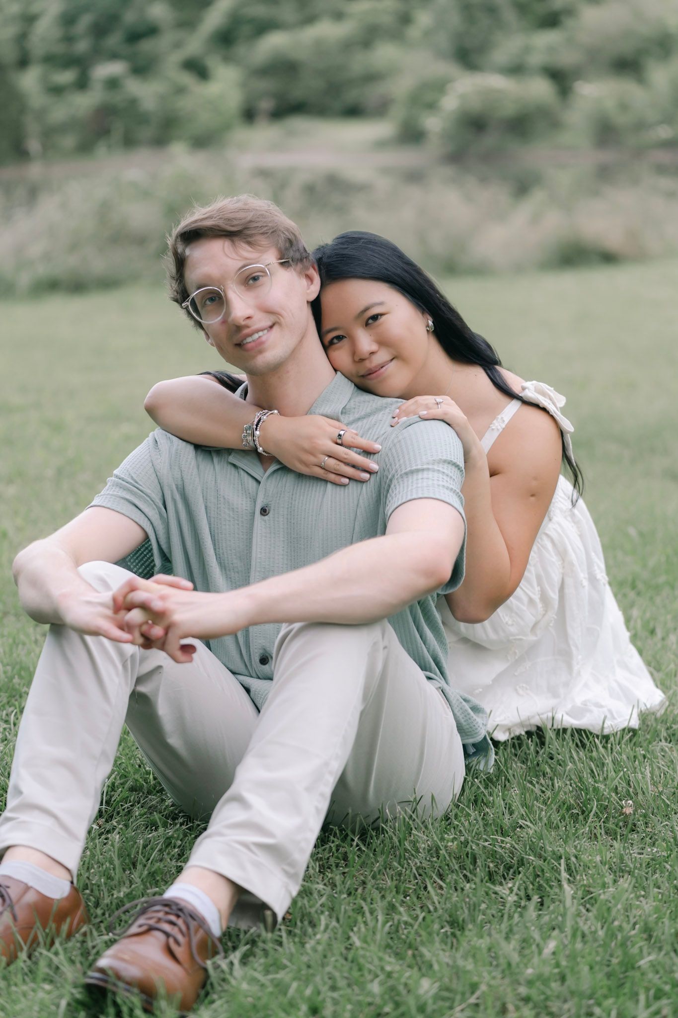 couple sitting together in a field during a Nashville area engagement session by best Knoxville photographer Anna Rose Photos