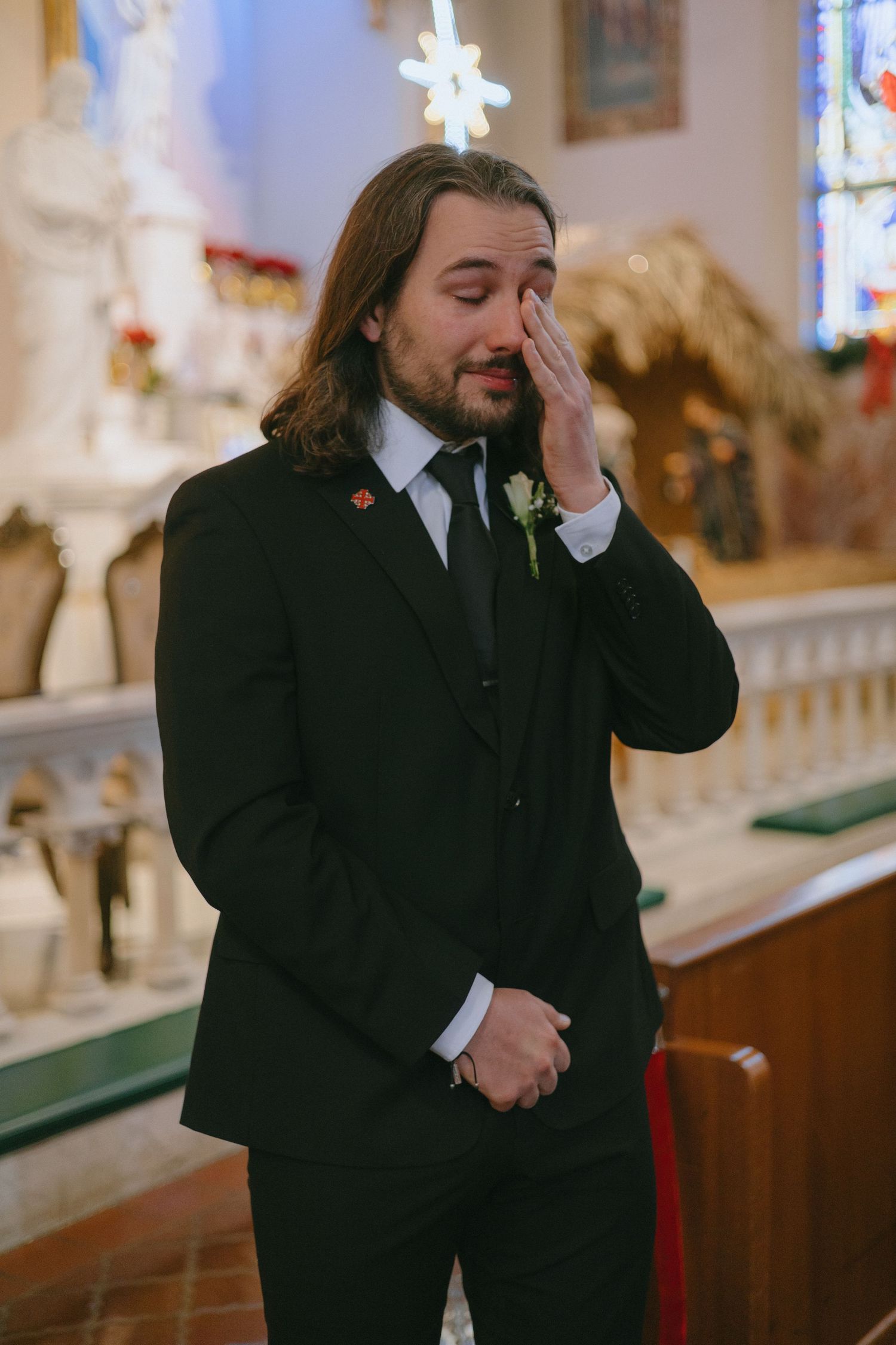 An emotional moment captured in a church with stained glass windows and ornate decor.