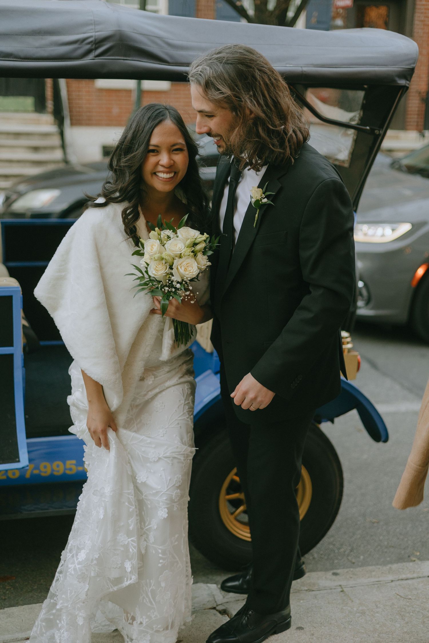 Happy couple shares joyful moments on their wedding day outdoors.