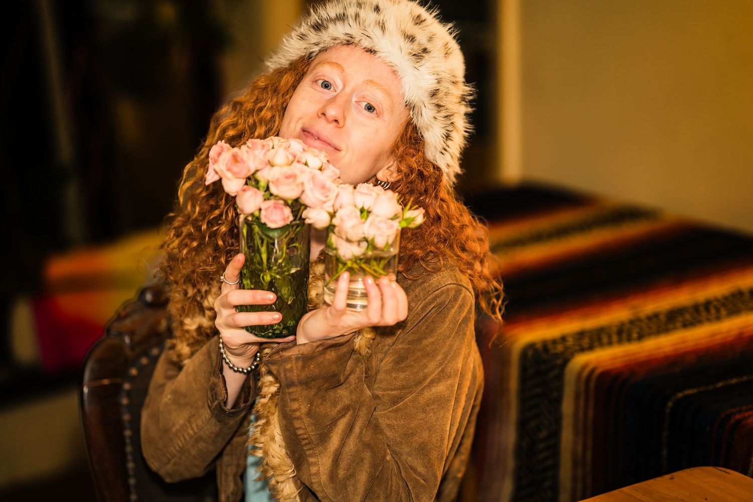 Person in vintage clothing poses indoors with dramatic lighting.