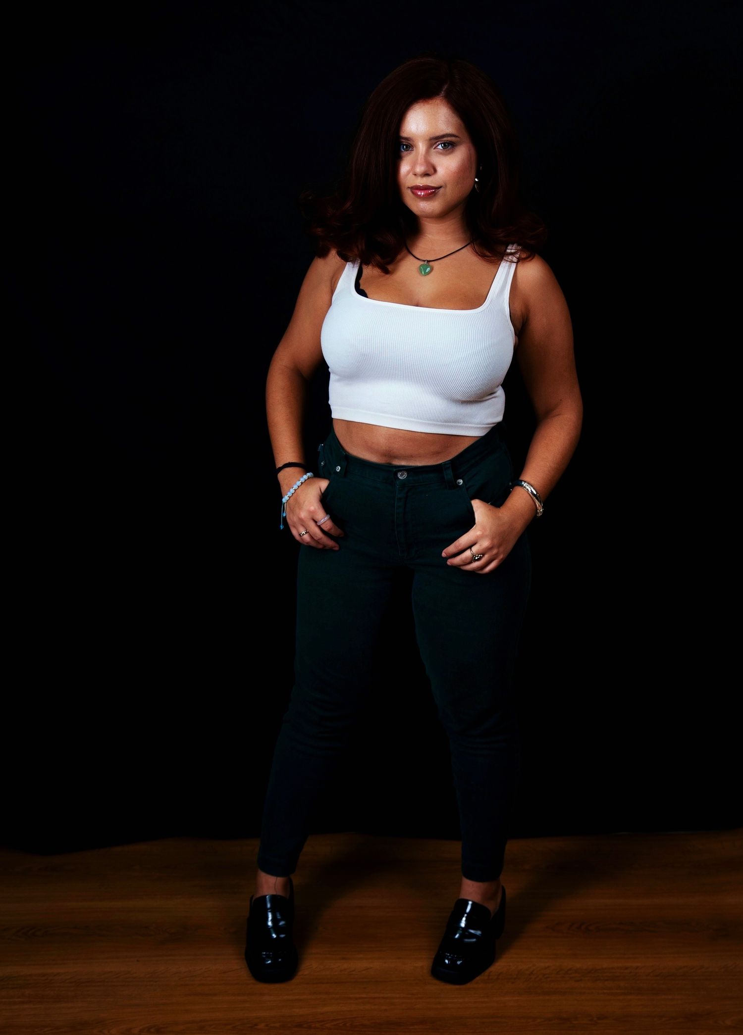 Athletic pose on wooden floor wearing activewear ensemble.