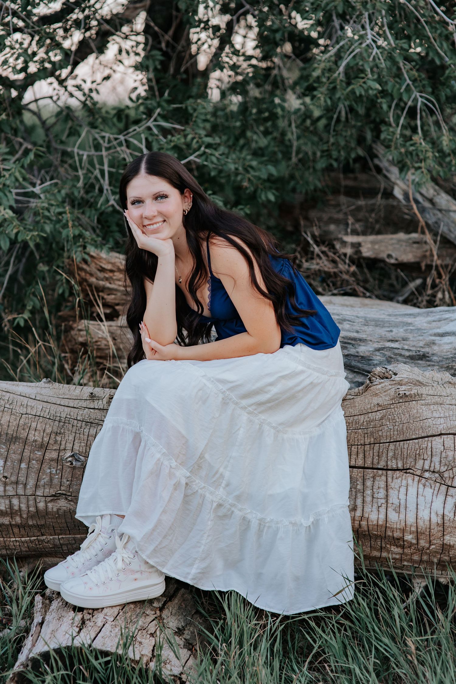 A Wyoming senior posing naturally for photography session with movement and soft light