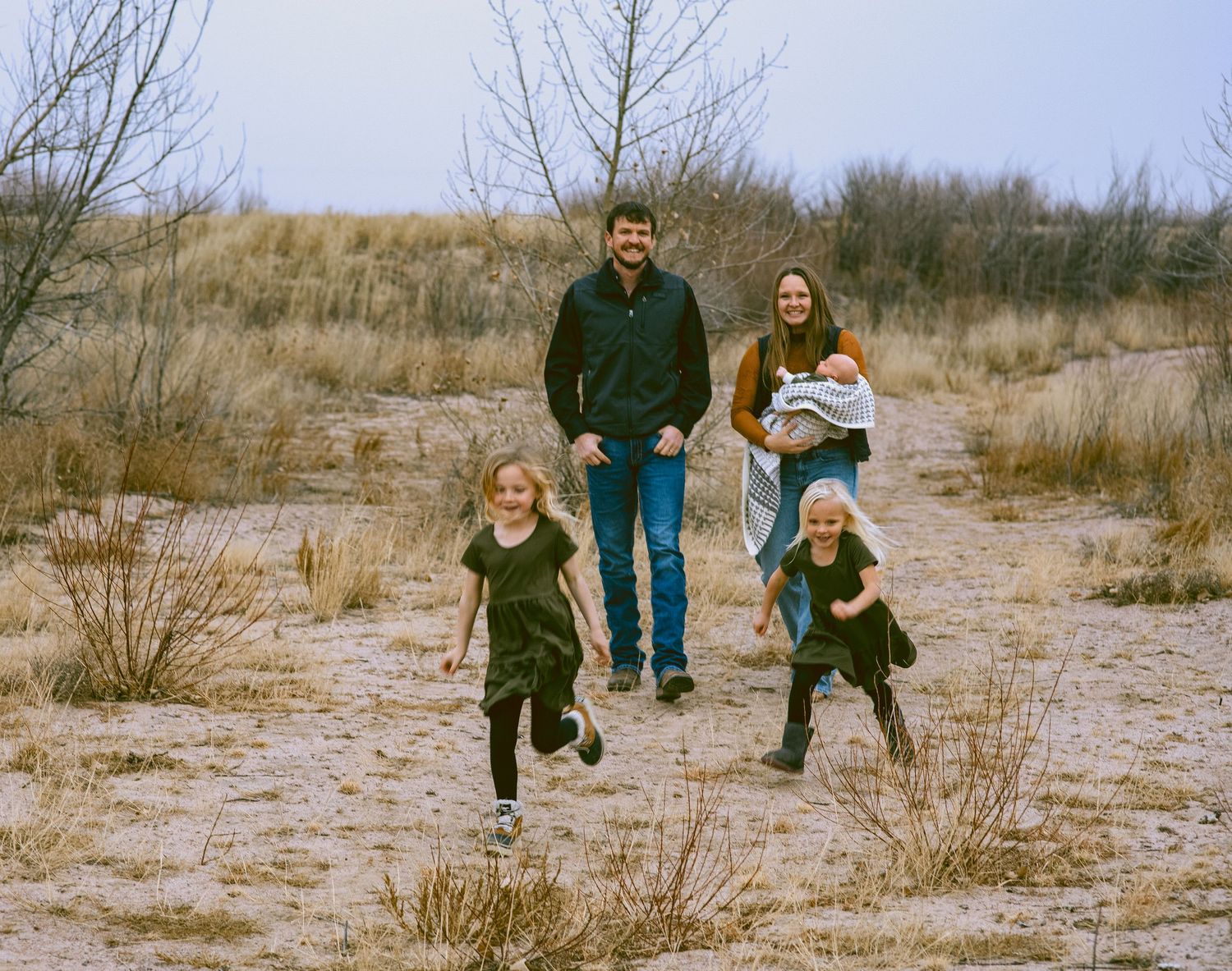 A sequence of candid family moments captured in desert terrain during a winter photoshoot in western nebraska
