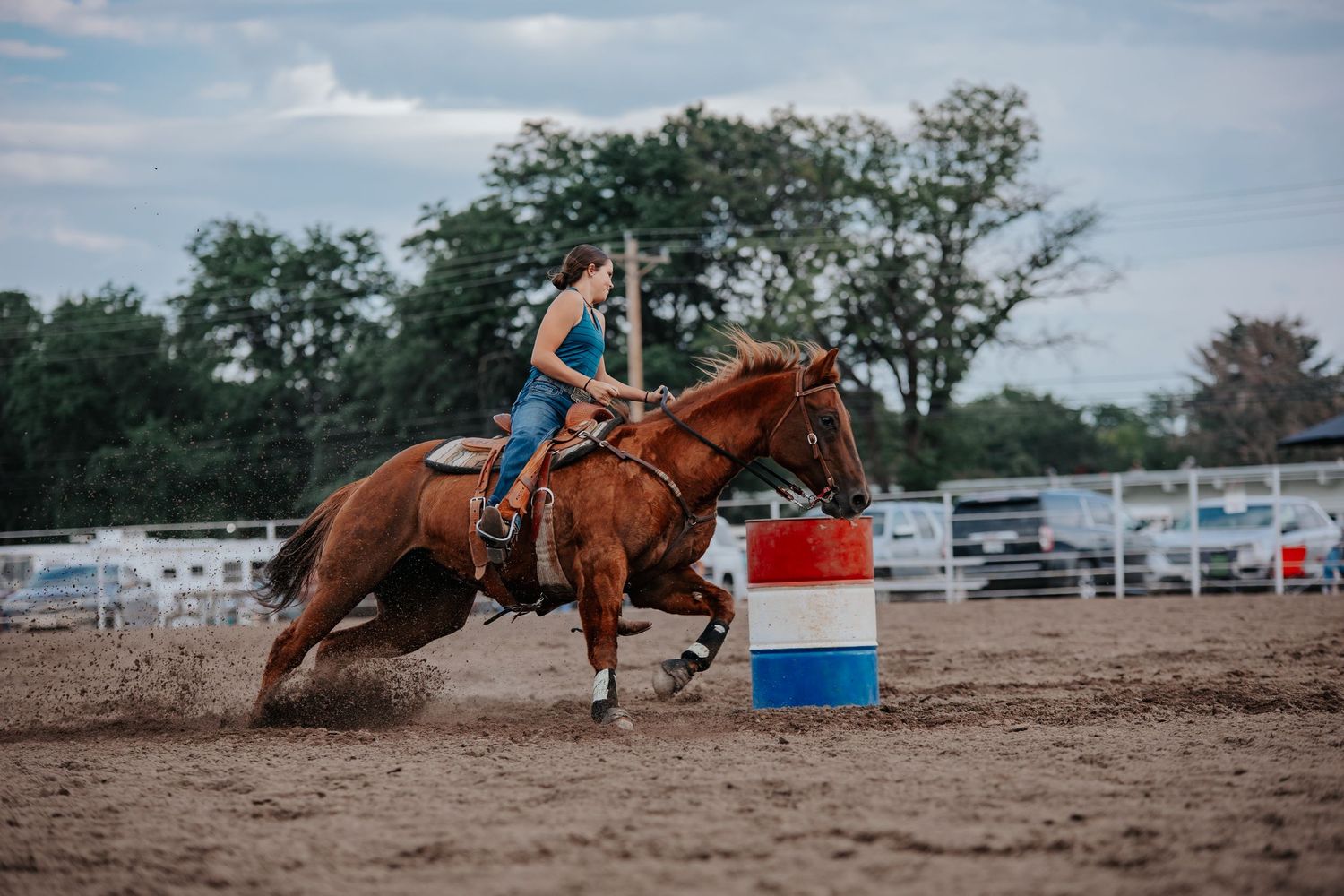 Horse and rider performing a barrel racing pattern at a western equestrian competition in Kimball Nebraska