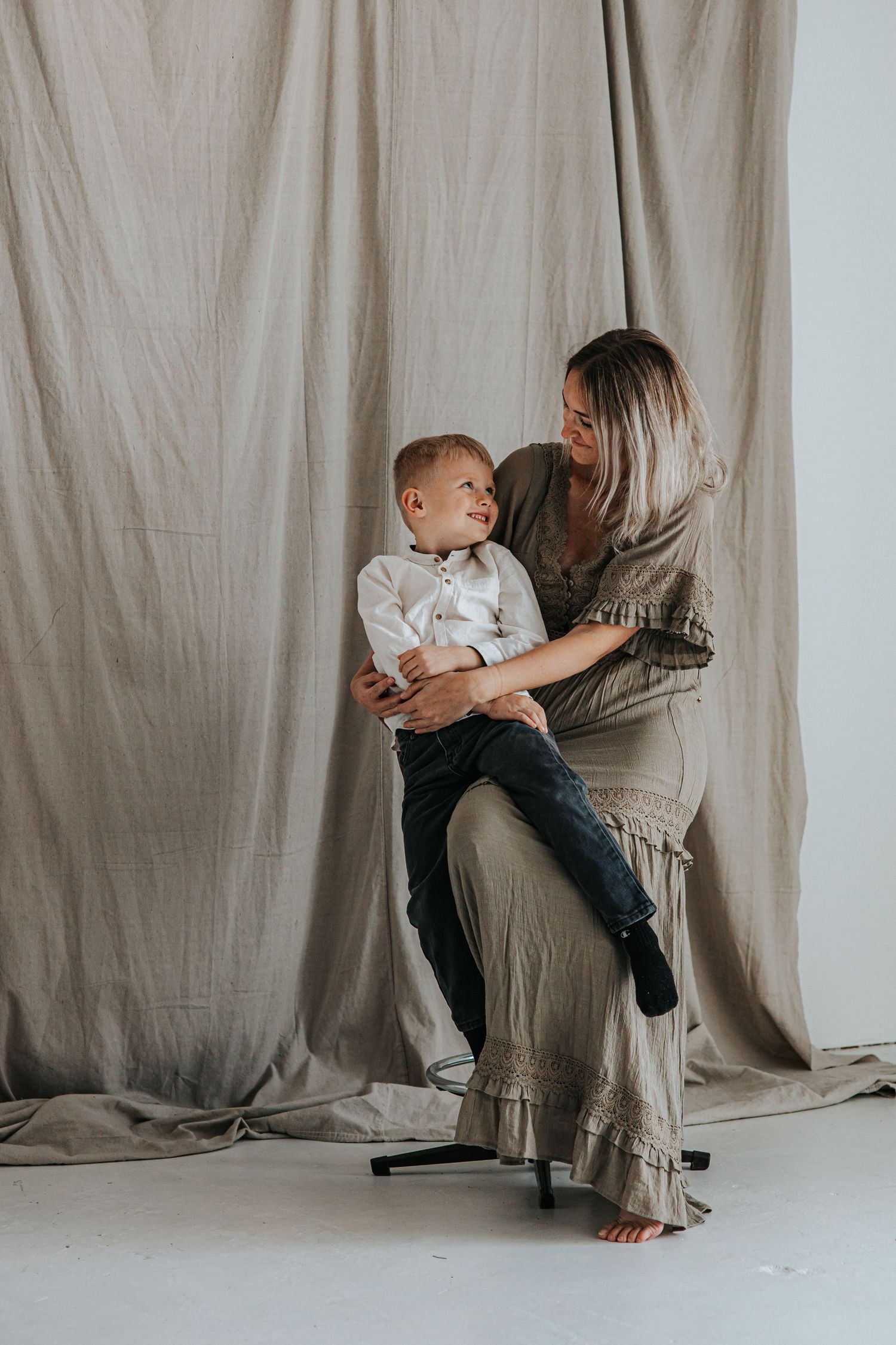 Studio portrait series showing tender moments against a neutral backdrop in Sidney Nebraska.