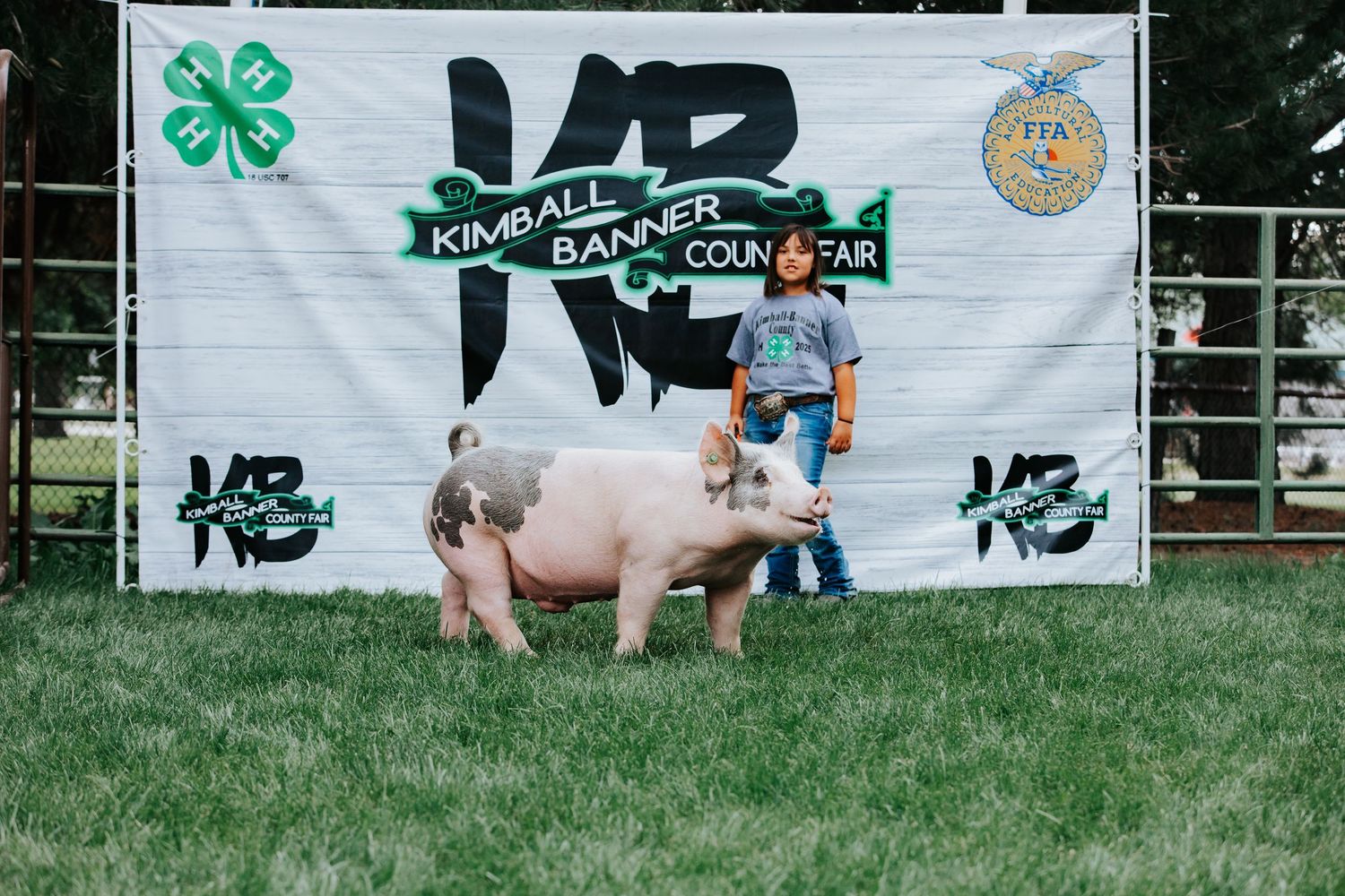 4H club banner display with livestock show participants and animals in Kimball Nebraska.