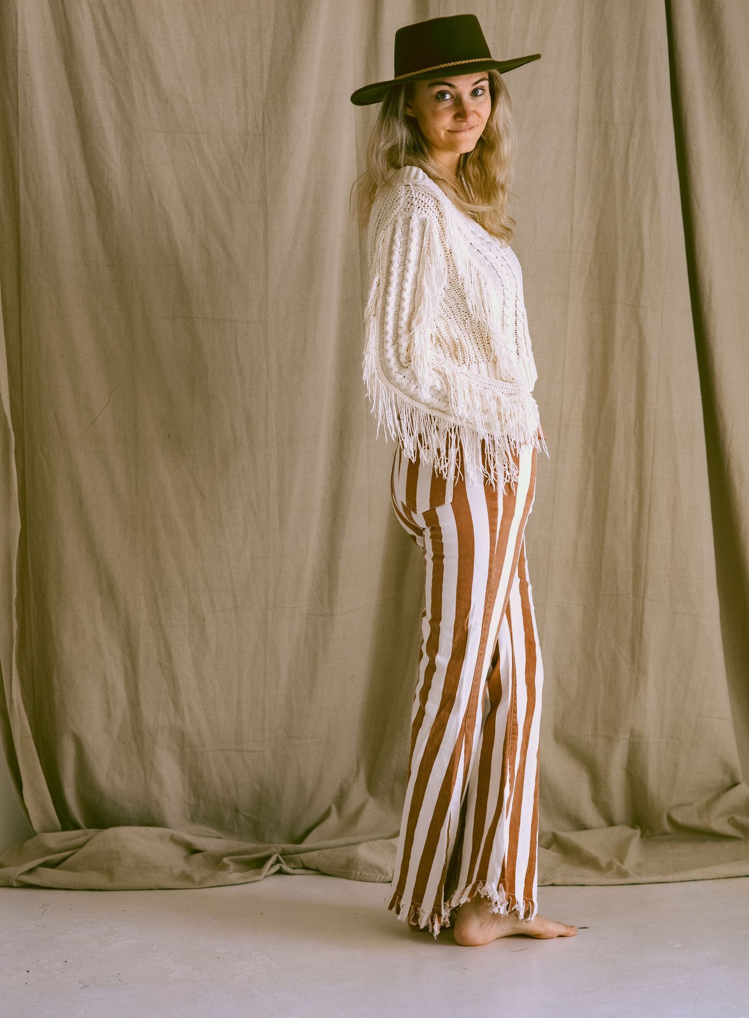 Fashion series showing western style outfits with striped pants and fringe details in Sidney Nebraska.