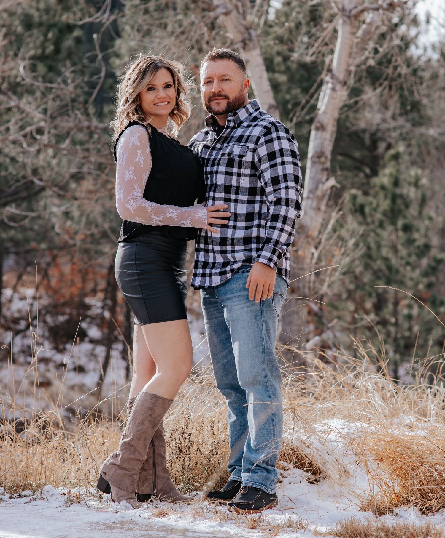 Rustic winter couple photoshoot with bare aspen trees in snowy background in Spearfish Canyon in Spearfish South Dakota.