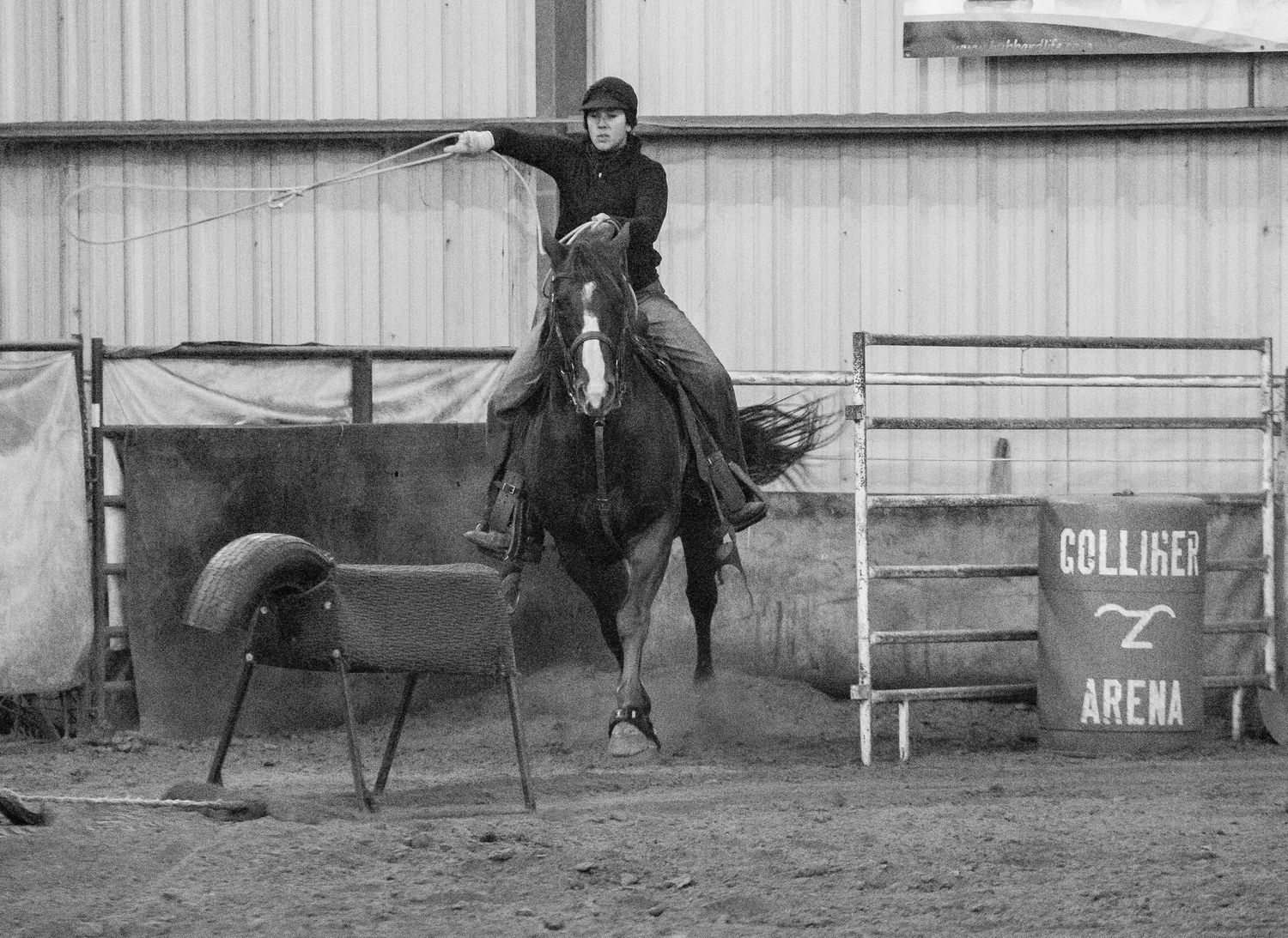 Black and white rodeo action shots showing riders performing in an arena in Belle Fourche South Dakota.