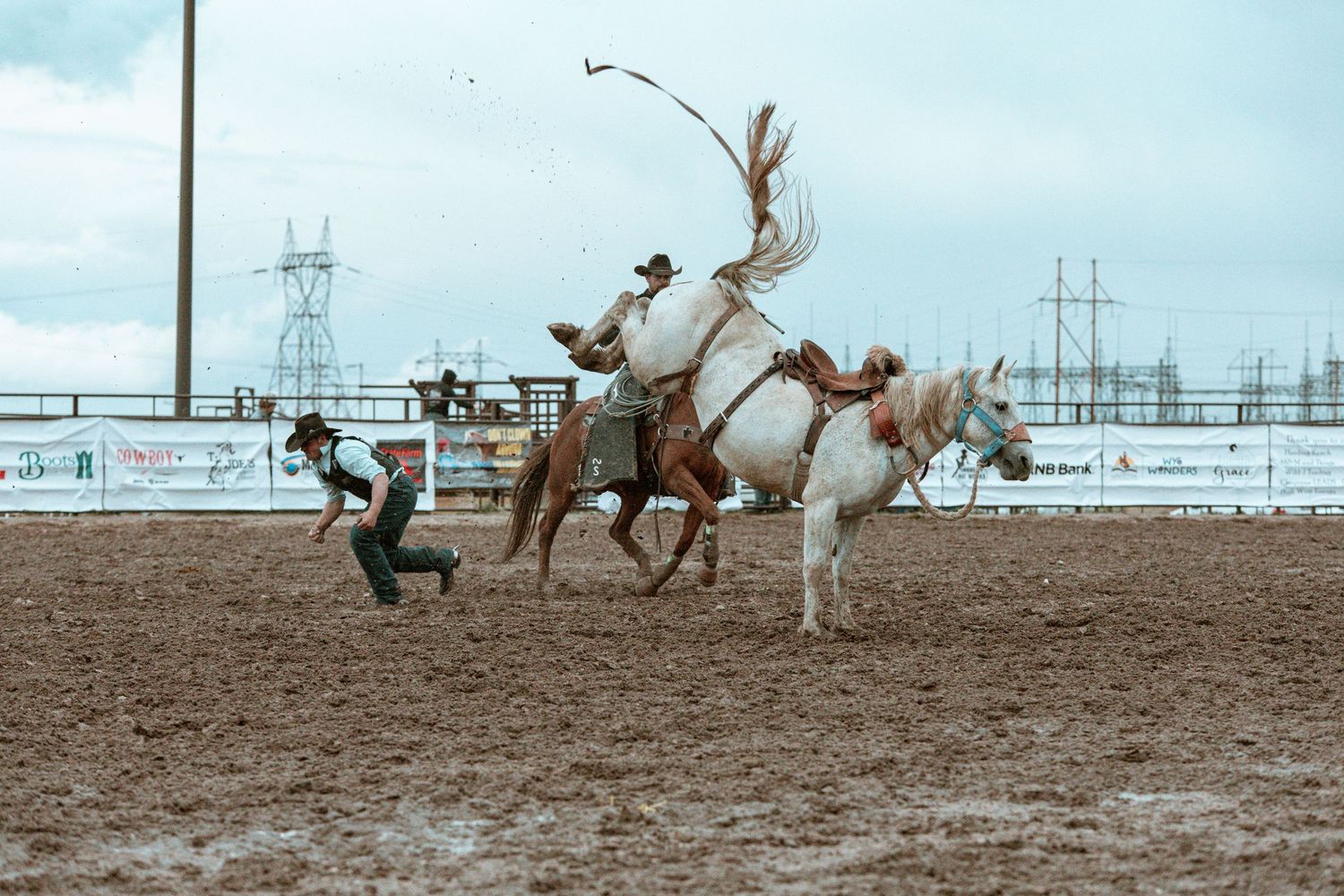 Dynamic shot of horses and riders in action during an intense rodeo competition.