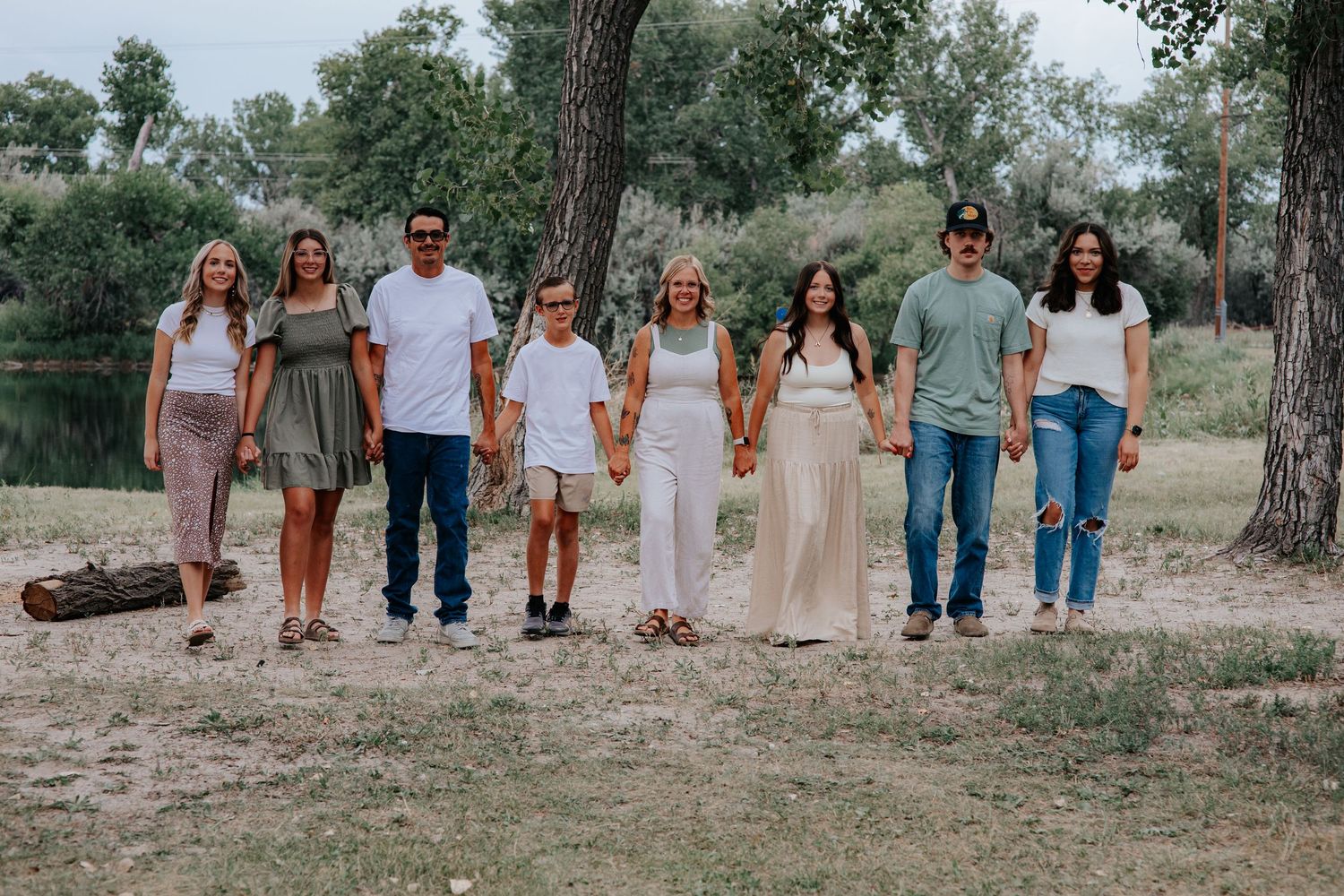 A group of people walking together outdoors wearing coordinated earth-toned and white outfits in a natural setting in Nebraska