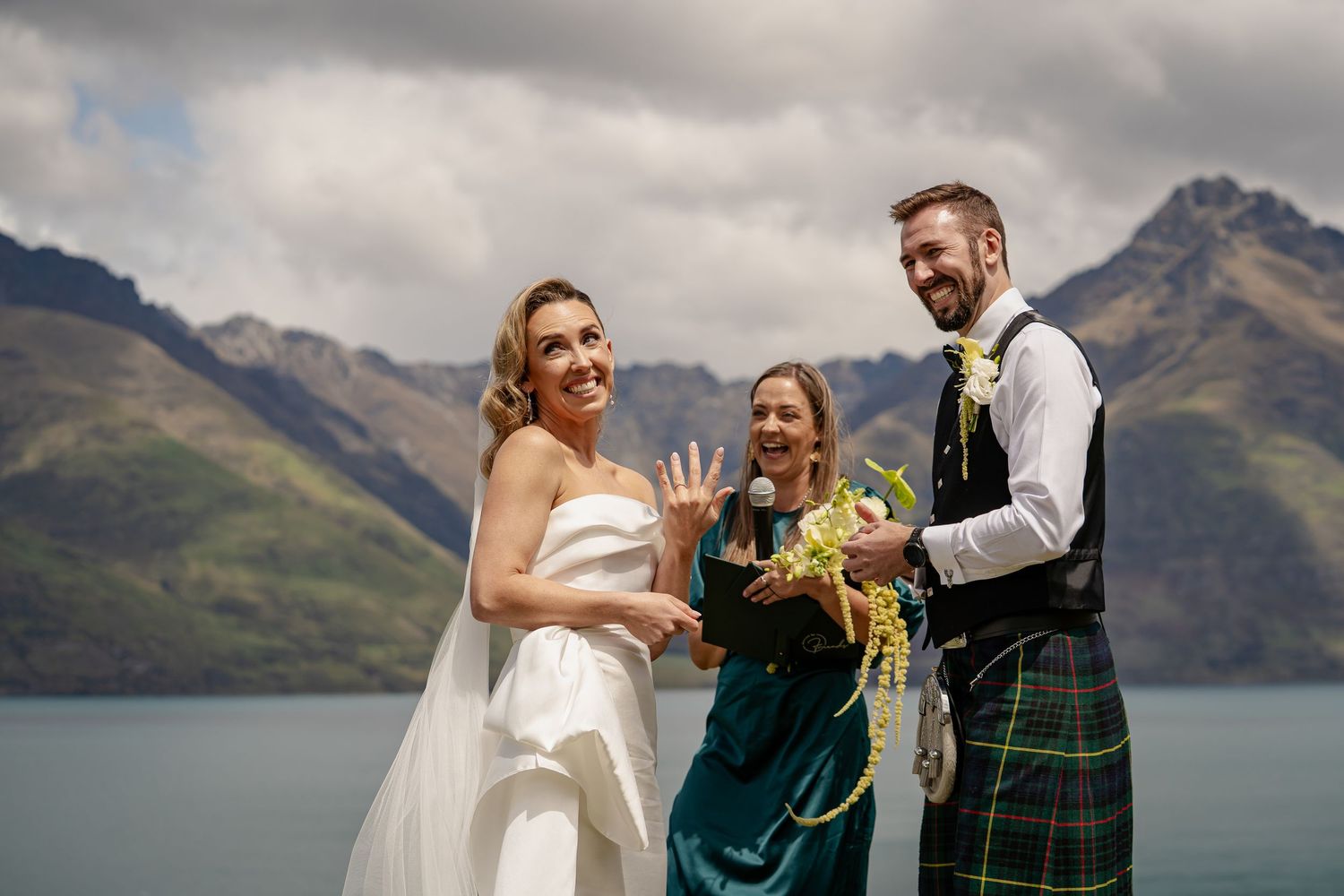 Bride and Groom showing off ring in front of Lake Wakatipu, Queenstown New Zealand.