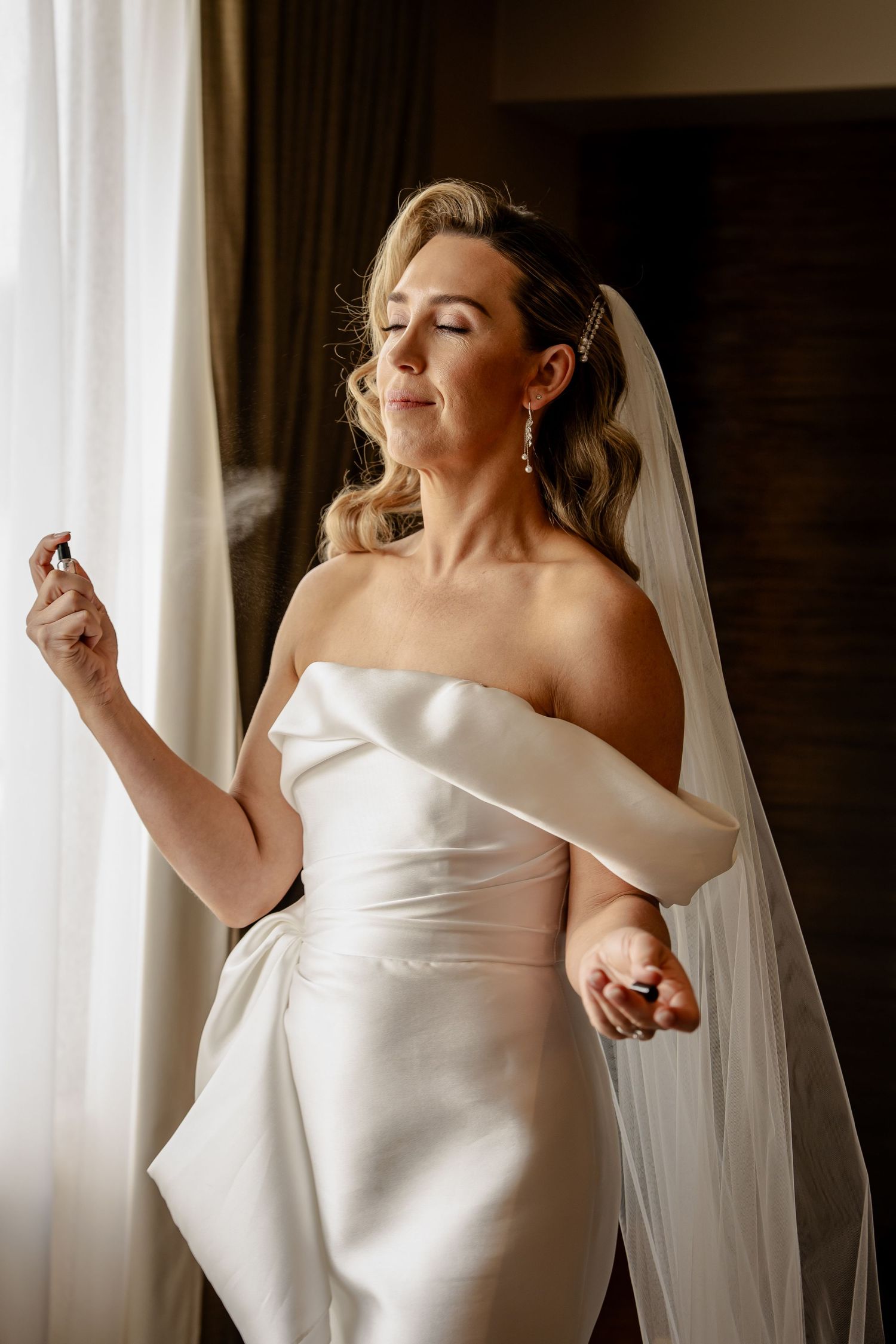 Bride spraying perfume in Queenstown, NZ.