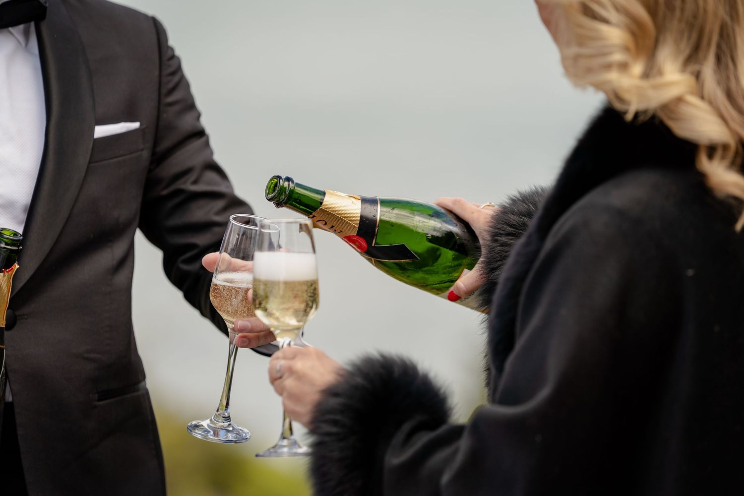 Wedding guests pouring champagne in Queenstown, NZ