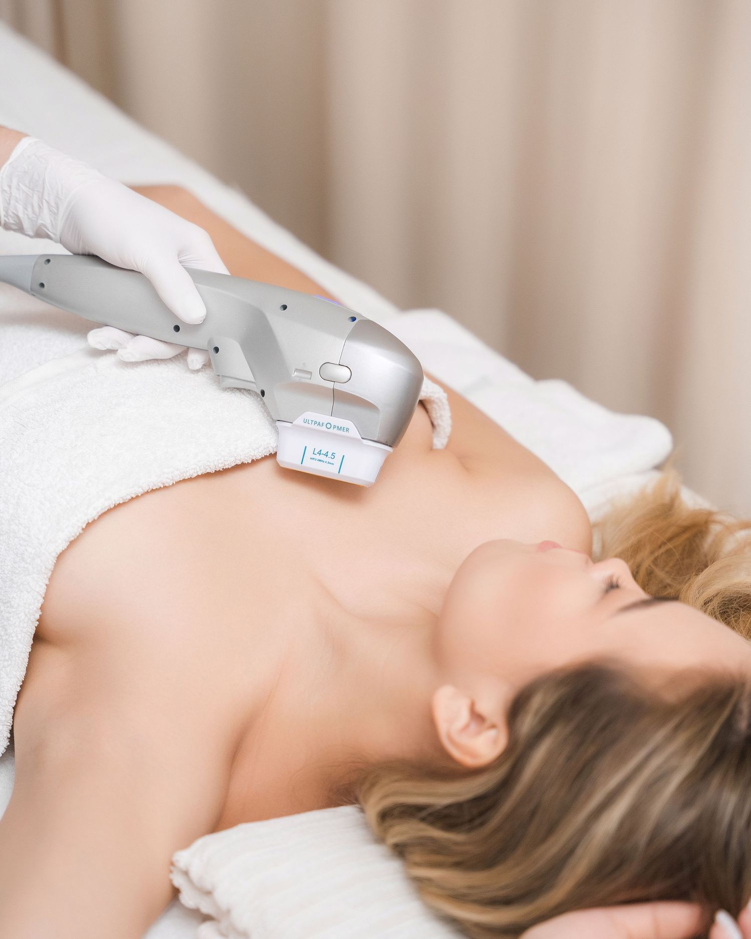 Cosmetic treatment being performed with specialized equipment in spa setting.