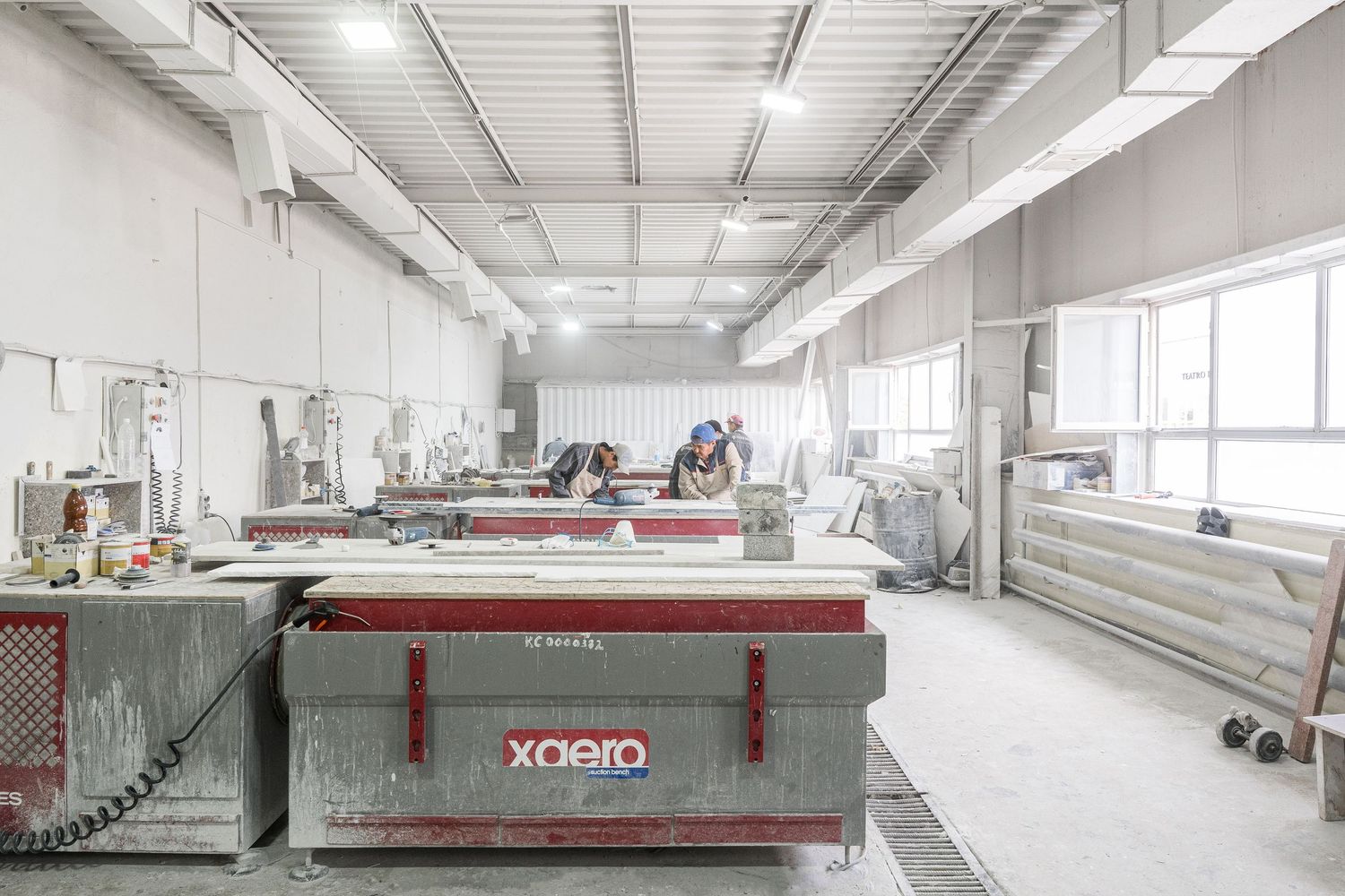 Large industrial manufacturing facility with machinery and equipment for stone processing.