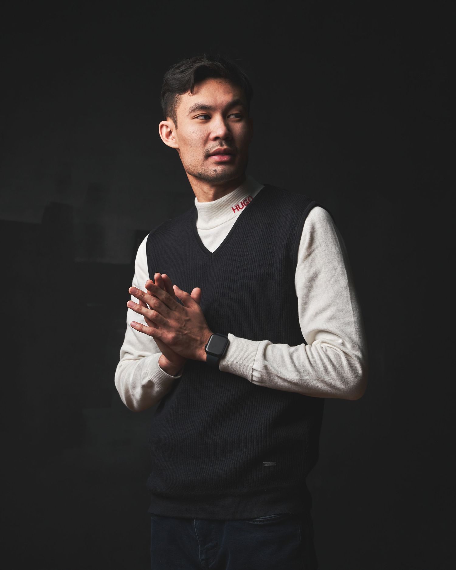 Professional portrait series showing hand gestures against dark background with dramatic lighting.