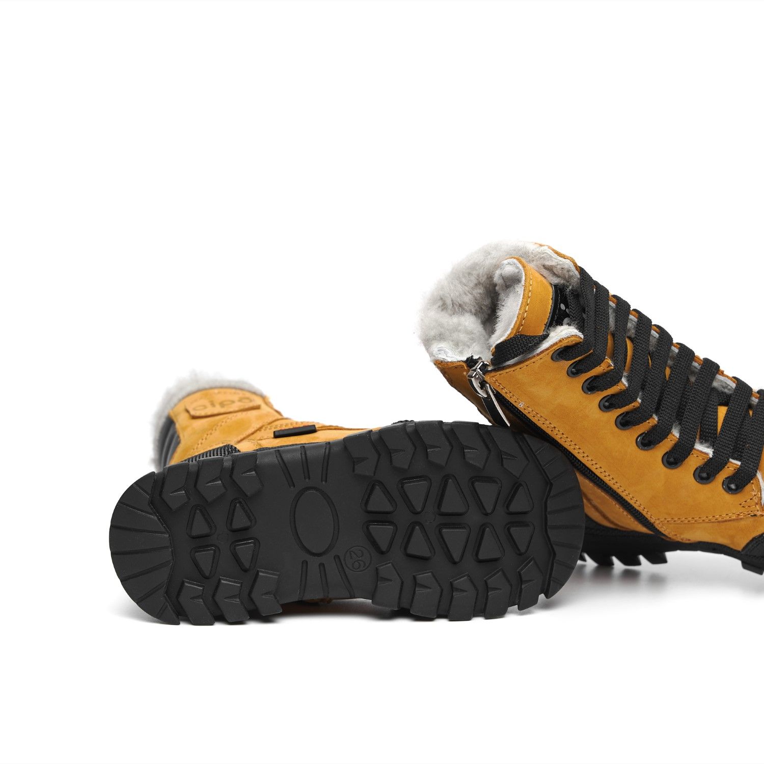 Heavy-duty rubber boot soles with deep treads shown against white background.