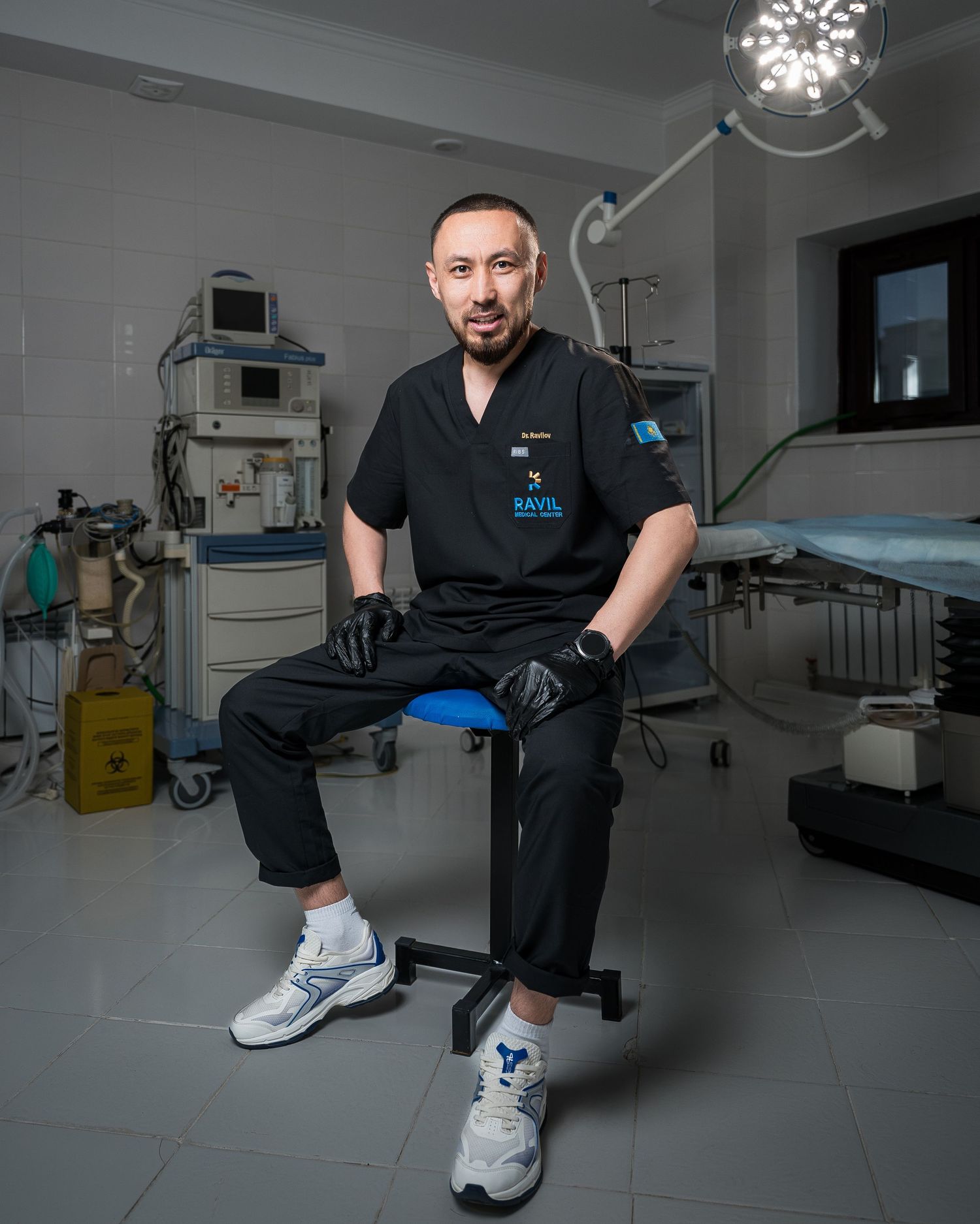 Medical professional in black scrubs demonstrating stretching exercises in clinical setting.