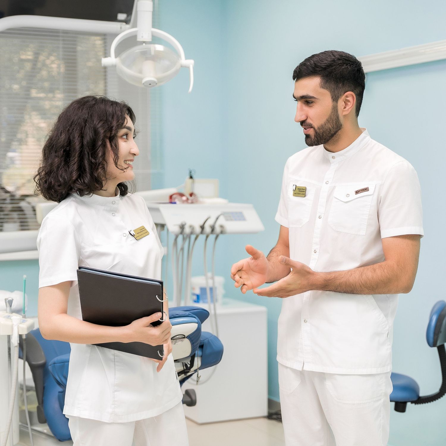 Healthcare team members collaborate and discuss patient care in a modern medical office.