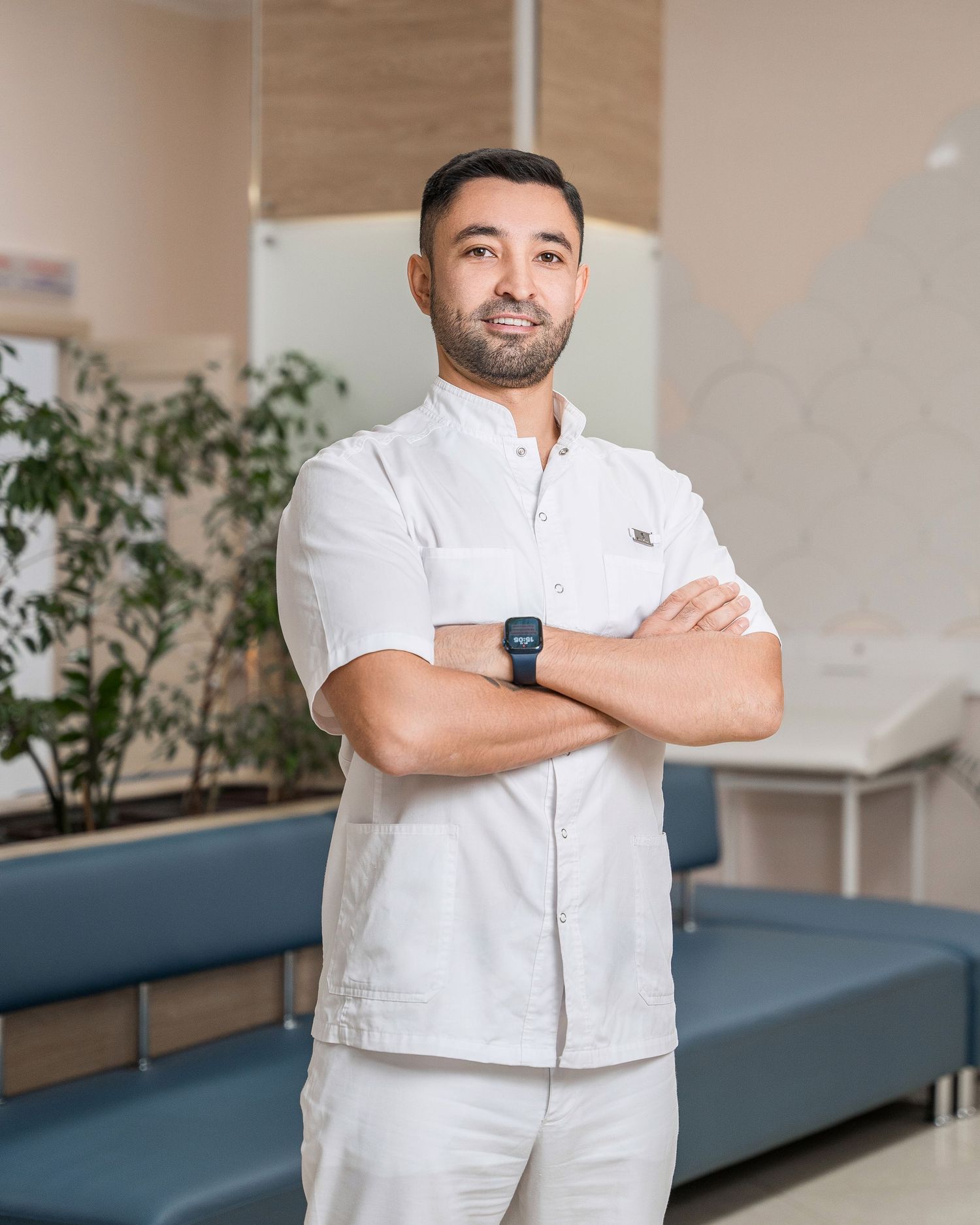 Healthcare workers in white uniforms stand professionally in a medical facility.