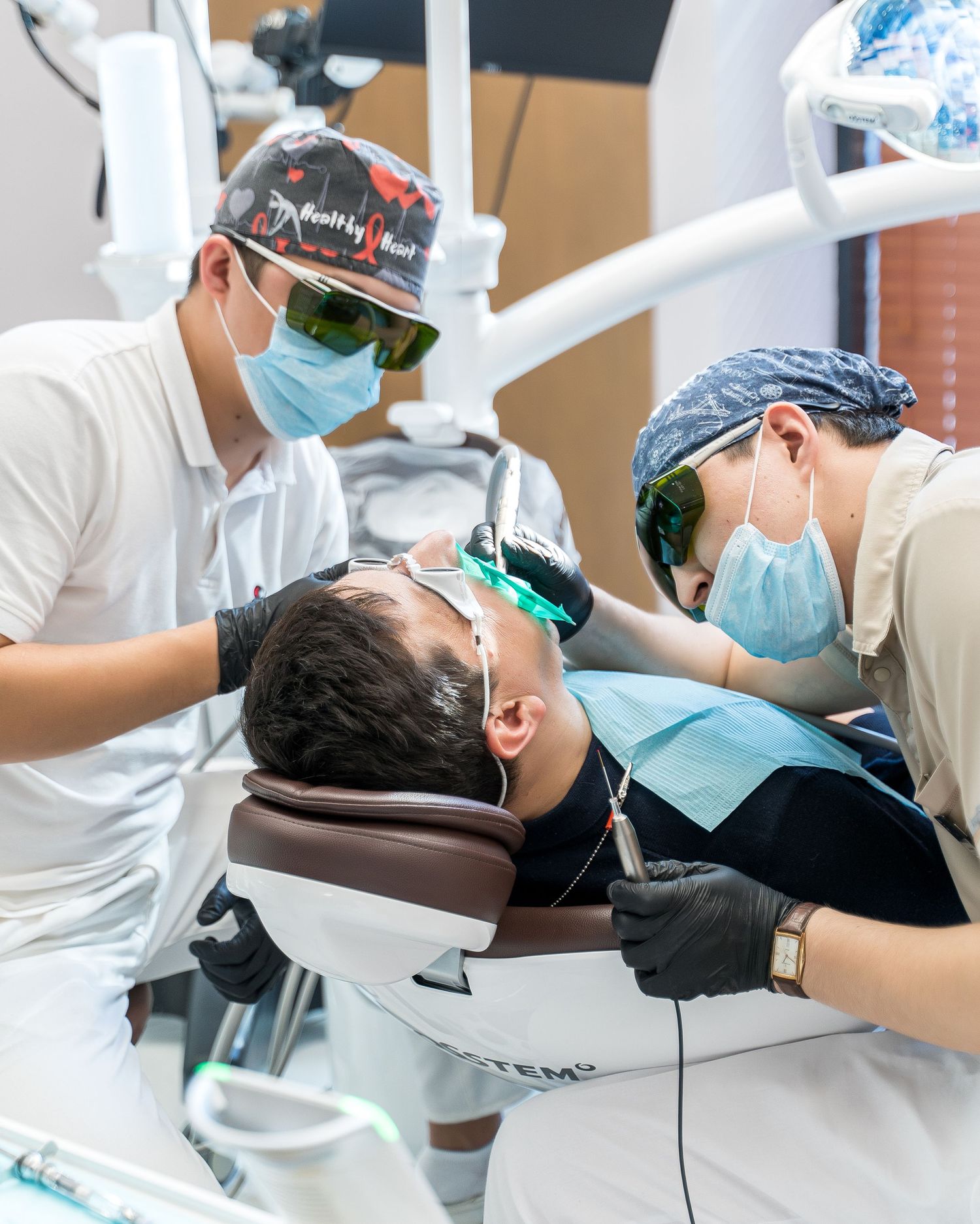 Dental procedure being performed with professional equipment in clinical setting.