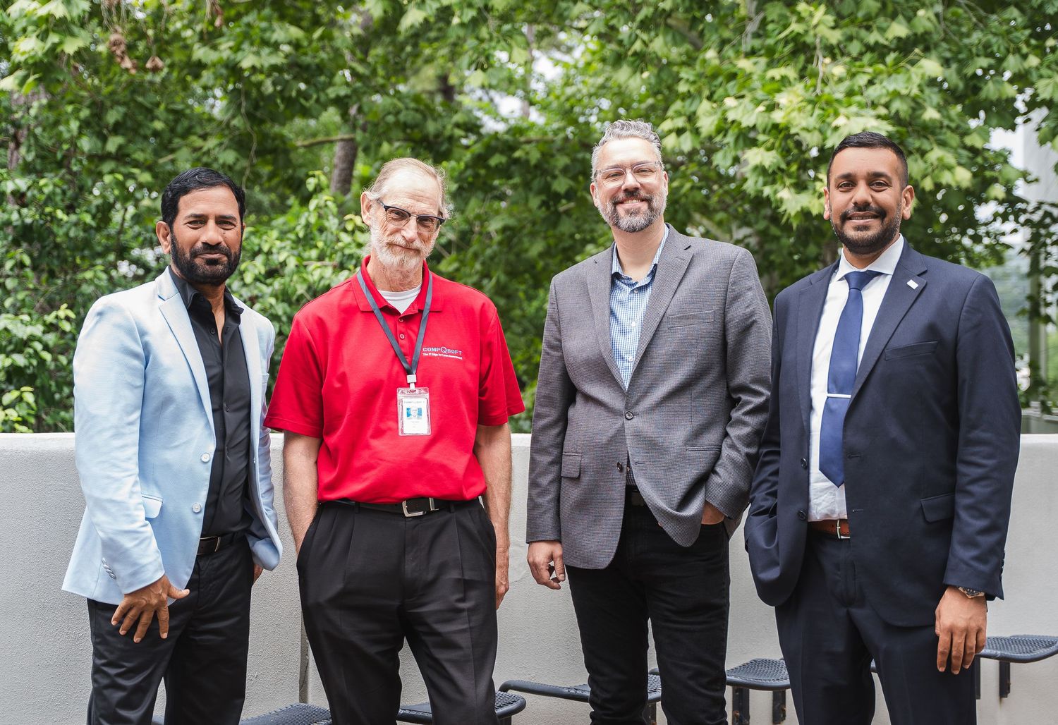 Group of business professionals standing together outdoors.