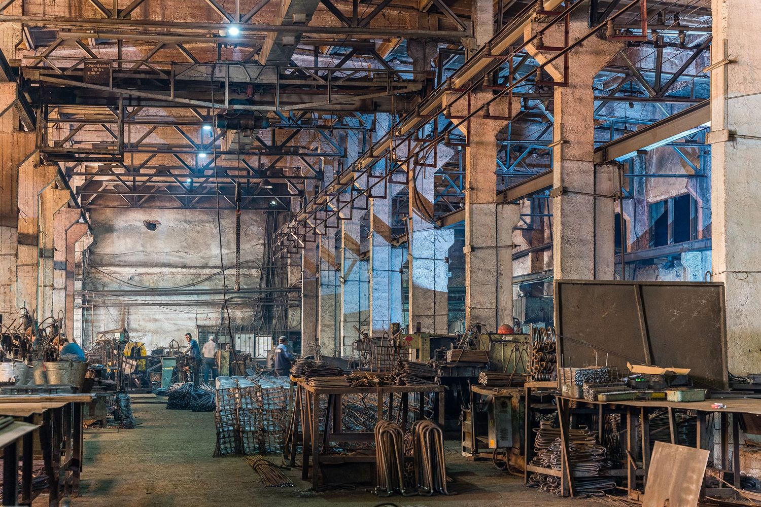 Manufacturing facility interior showing extensive production lines and overhead lighting.