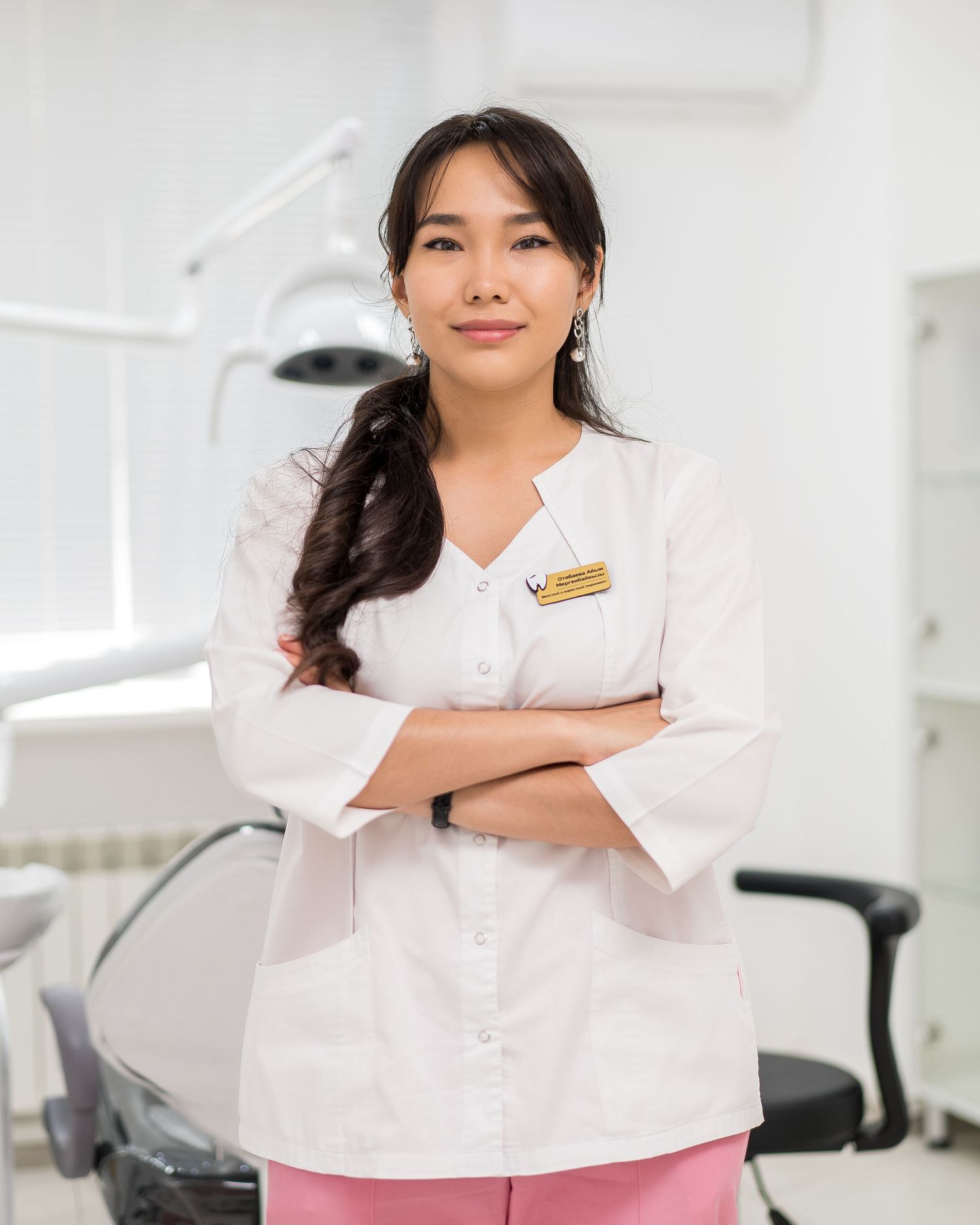 Medical professionals in white uniforms demonstrate confident poses in a clinical environment.