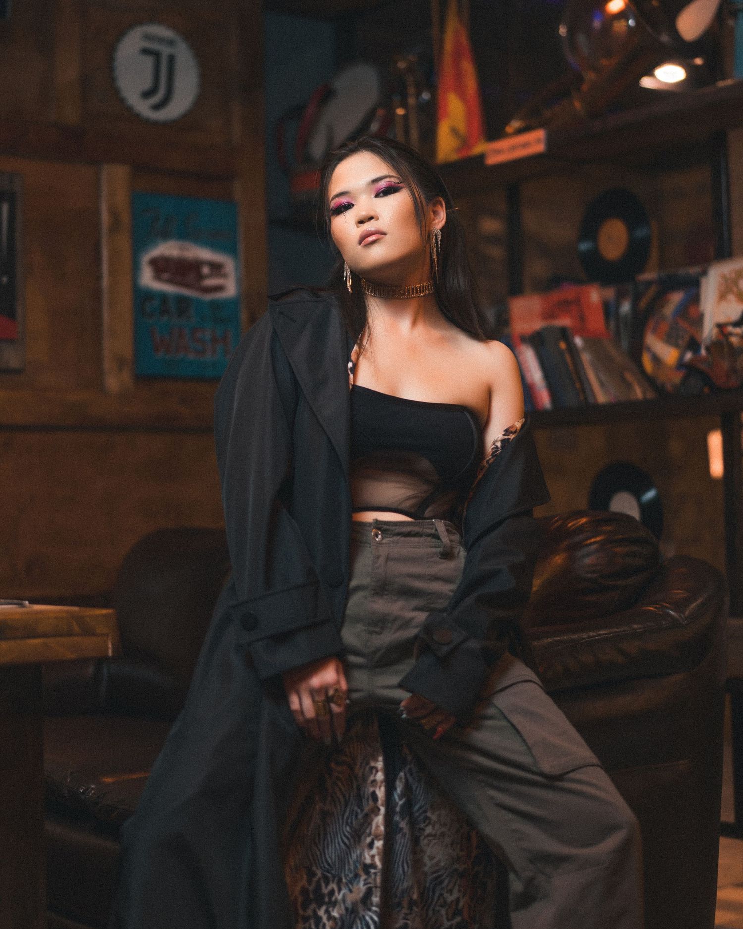 Dramatic fashion photography in dark setting with moody lighting and black attire.