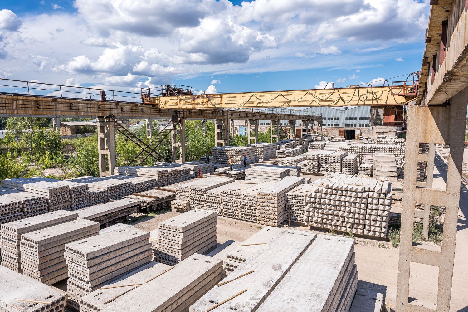 Concrete blocks and construction materials stored in an outdoor industrial yard.