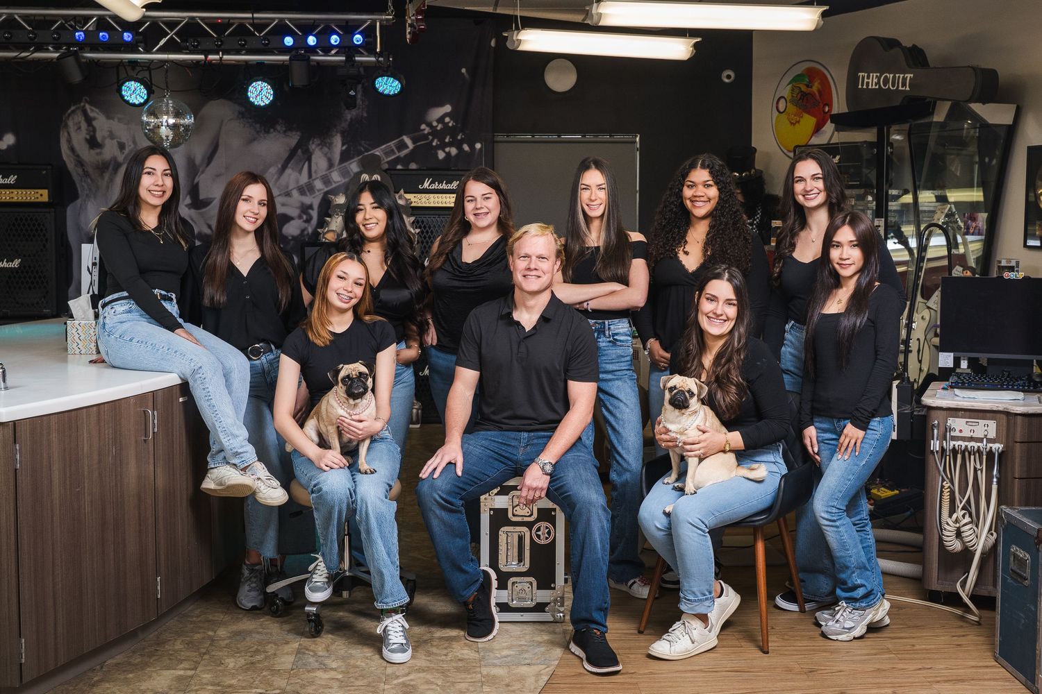 Group photo of dental office staff in casual attire.