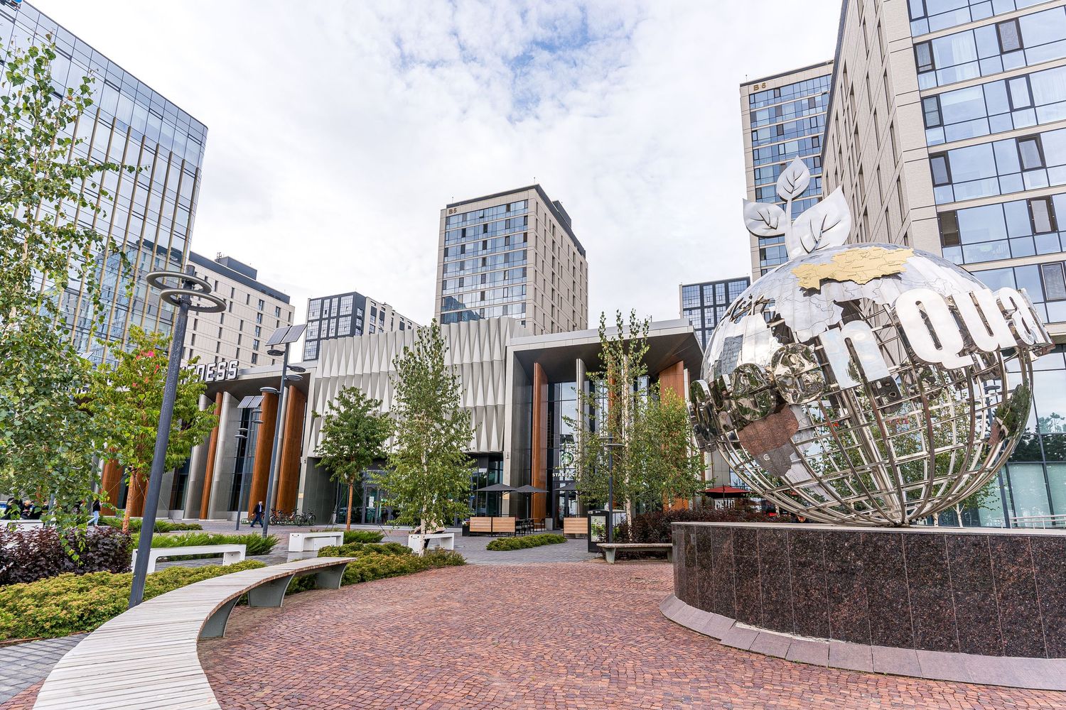 Contemporary commercial building exterior with curved walkway and architectural details.