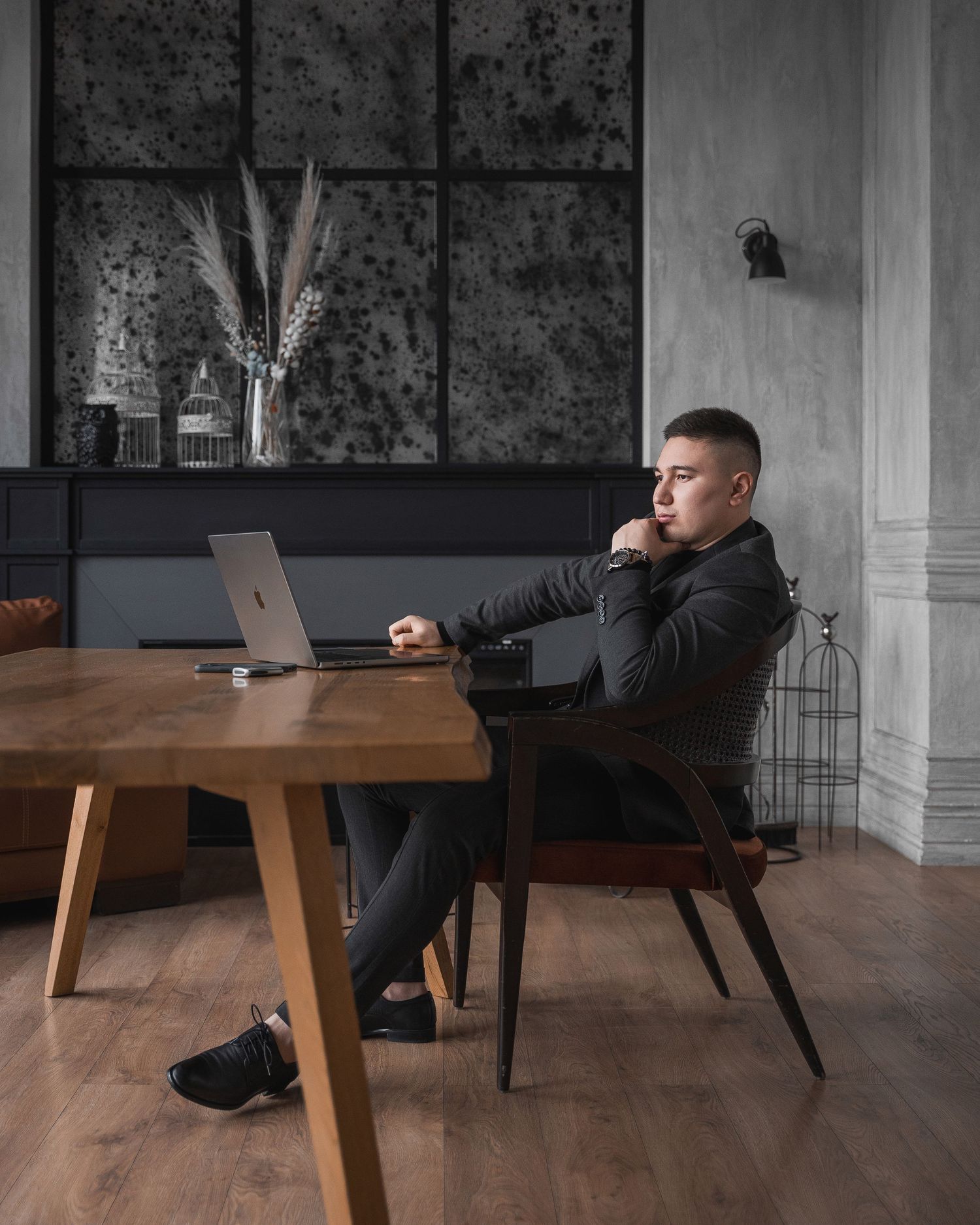 Modern office interior with wooden table and professional working setup.