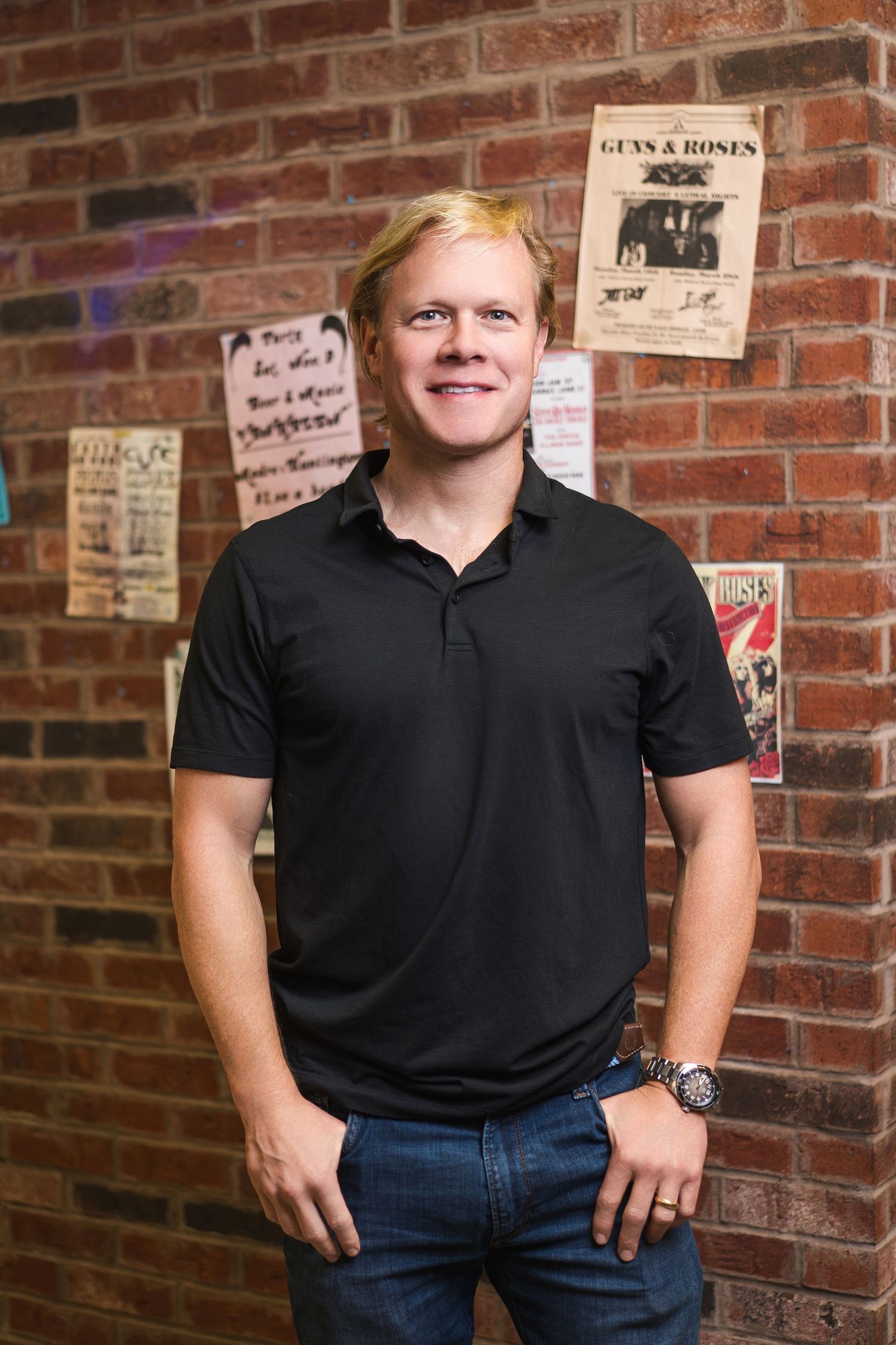 Professional headshots against brick wall background in casual black attire.
