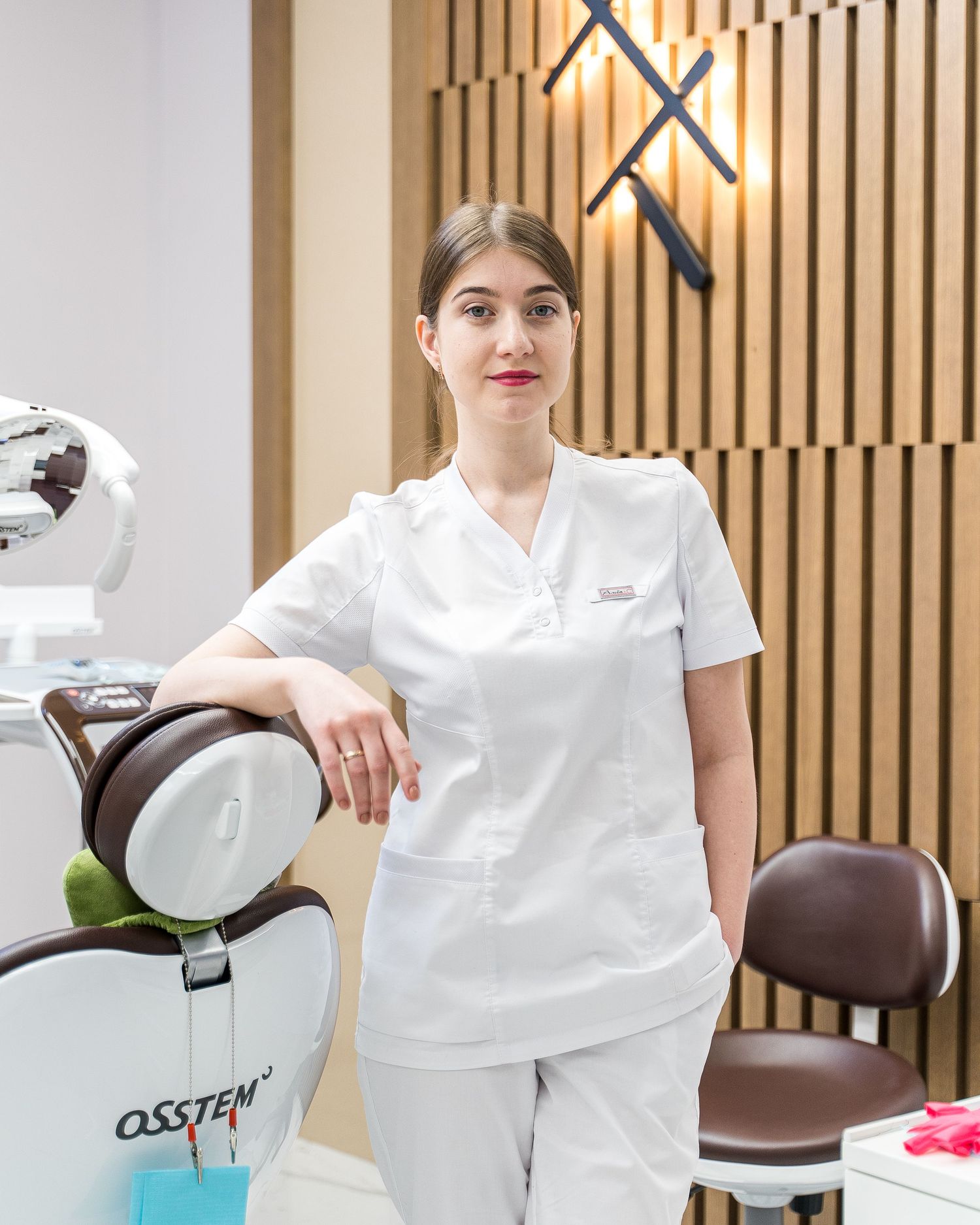 Dental office interior with modern chair and equipment setup.