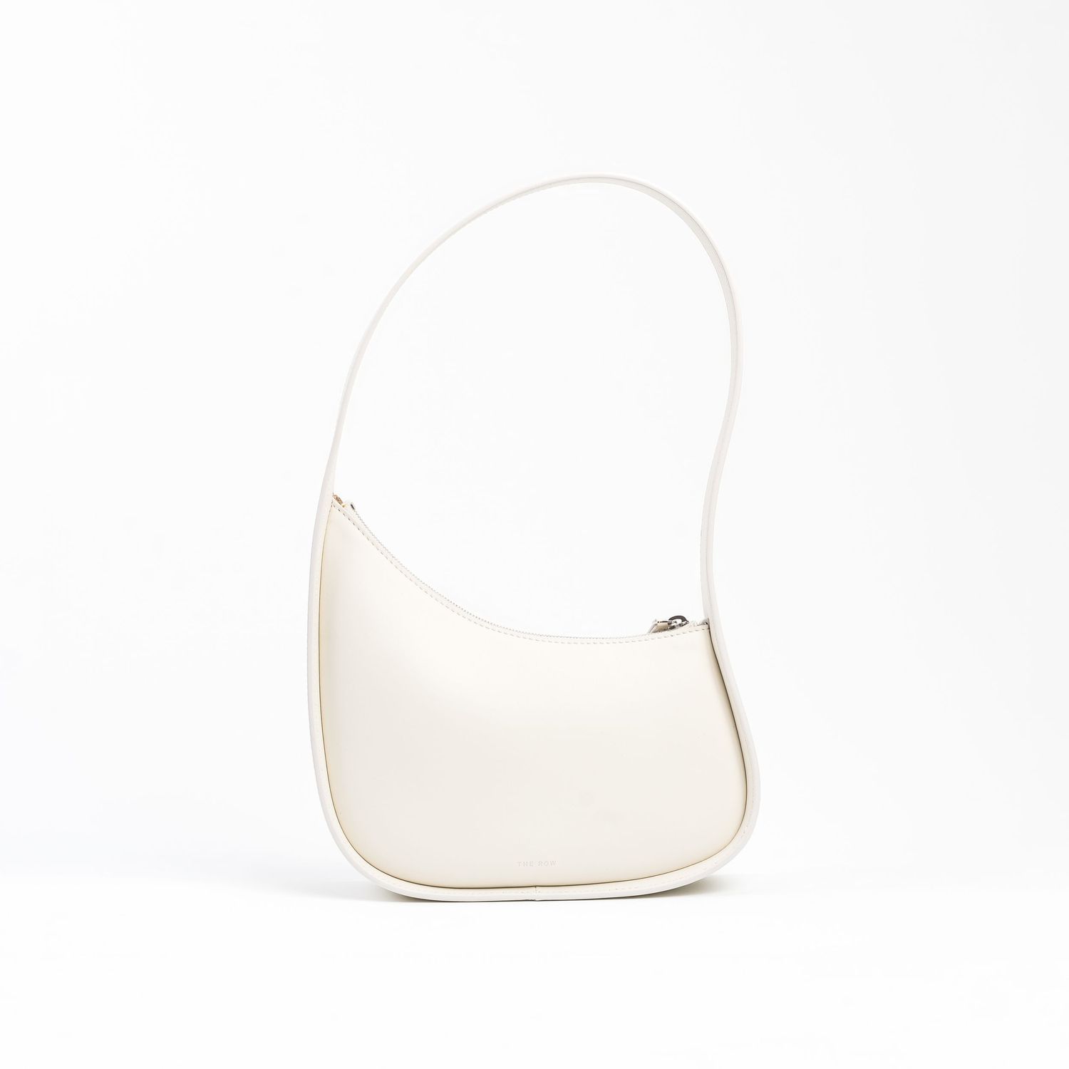 Elegant white leather handbag with curved silhouette photographed from multiple angles.