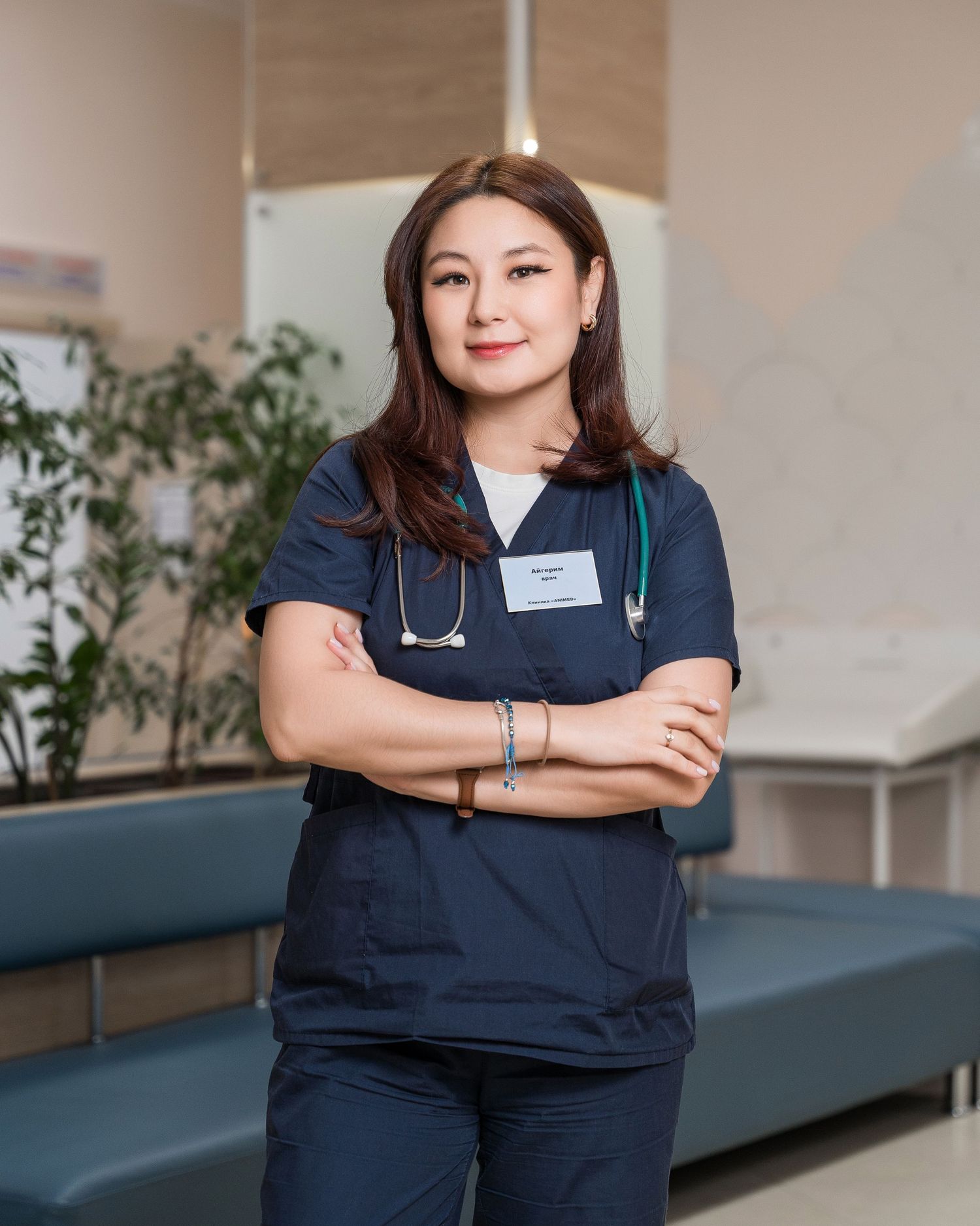Medical staff in navy blue uniforms pose confidently in a clinical setting.