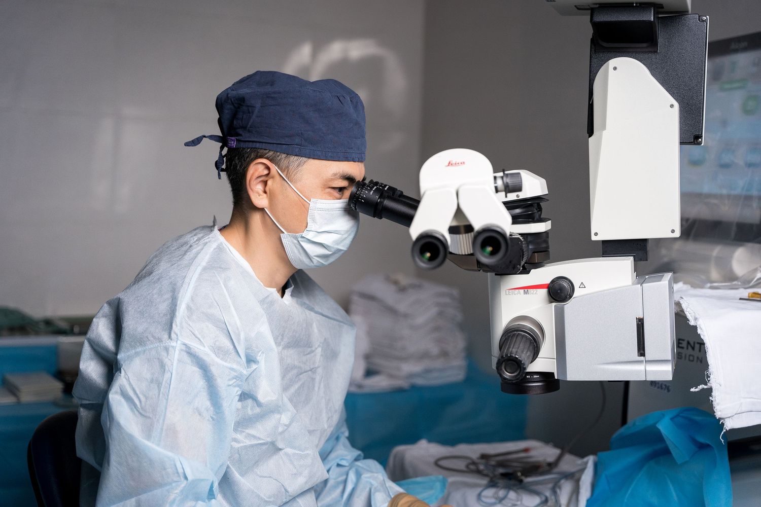 Healthcare worker using advanced medical equipment in a sterile operating environment.